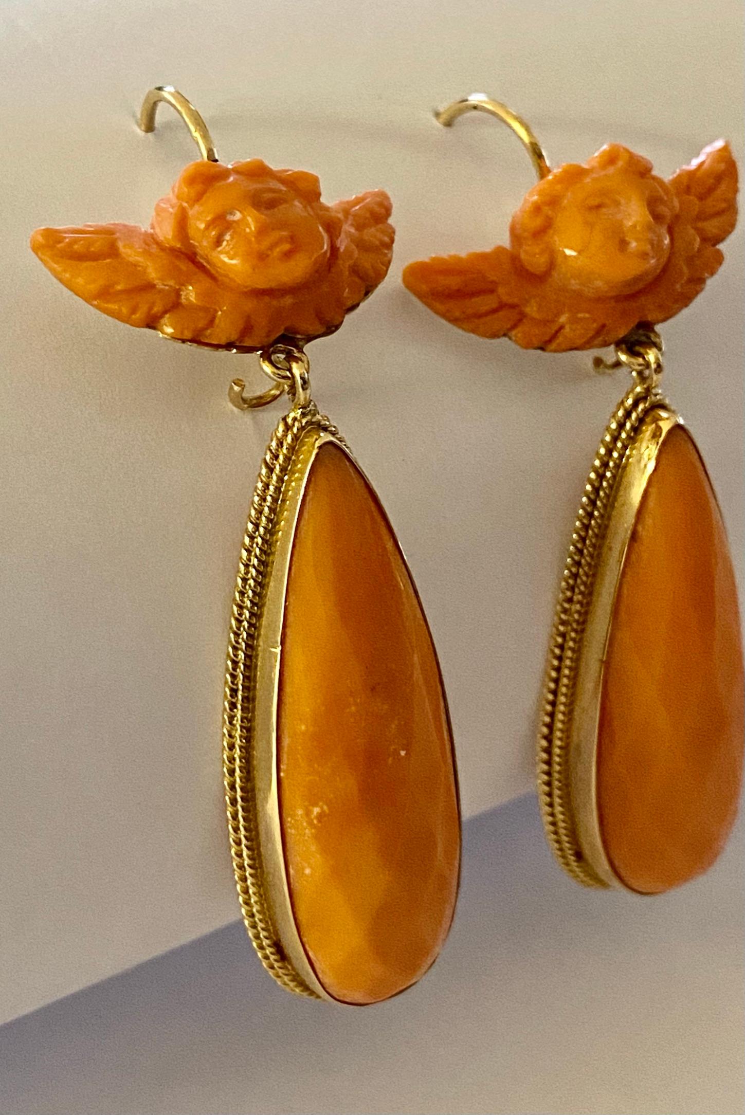 - 585/- gold earrings.
- red coral; 2x angel head,
   billed level.
- Total weight (both) = 15.39 grams
- Natural coral (untreated)
- Italy ca 1965
- Maker's mark: 499NA = Cuocolo
   Vicenza from Naples.