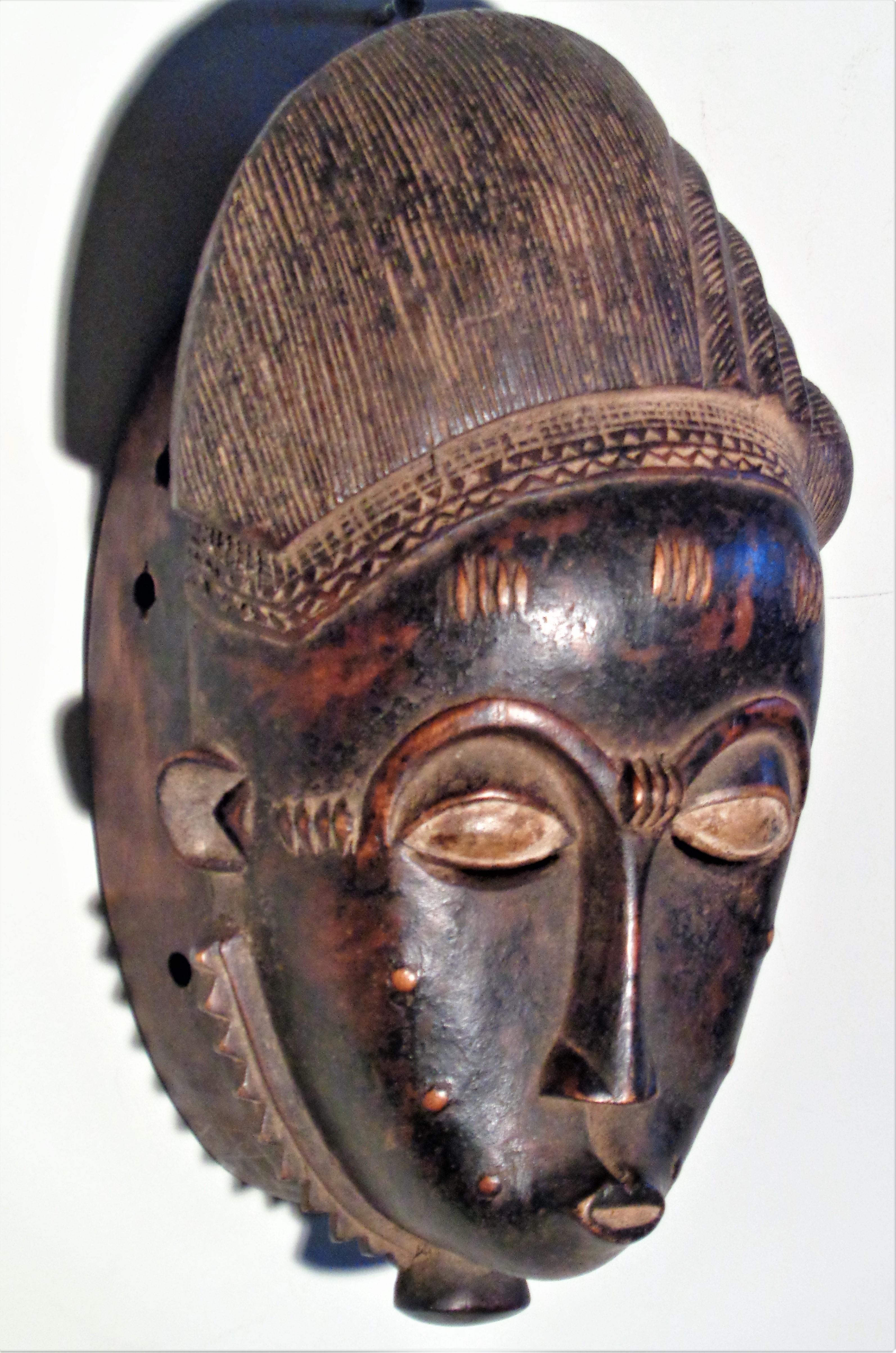Baule People portrait mask from the Ivory Coast, Africa. Finely carved with a naturally worn and beautifully aged original old pigmented surface. Circa 1900 - 1940. Good antique mask. Look at all pictures and read condition report in comment section.