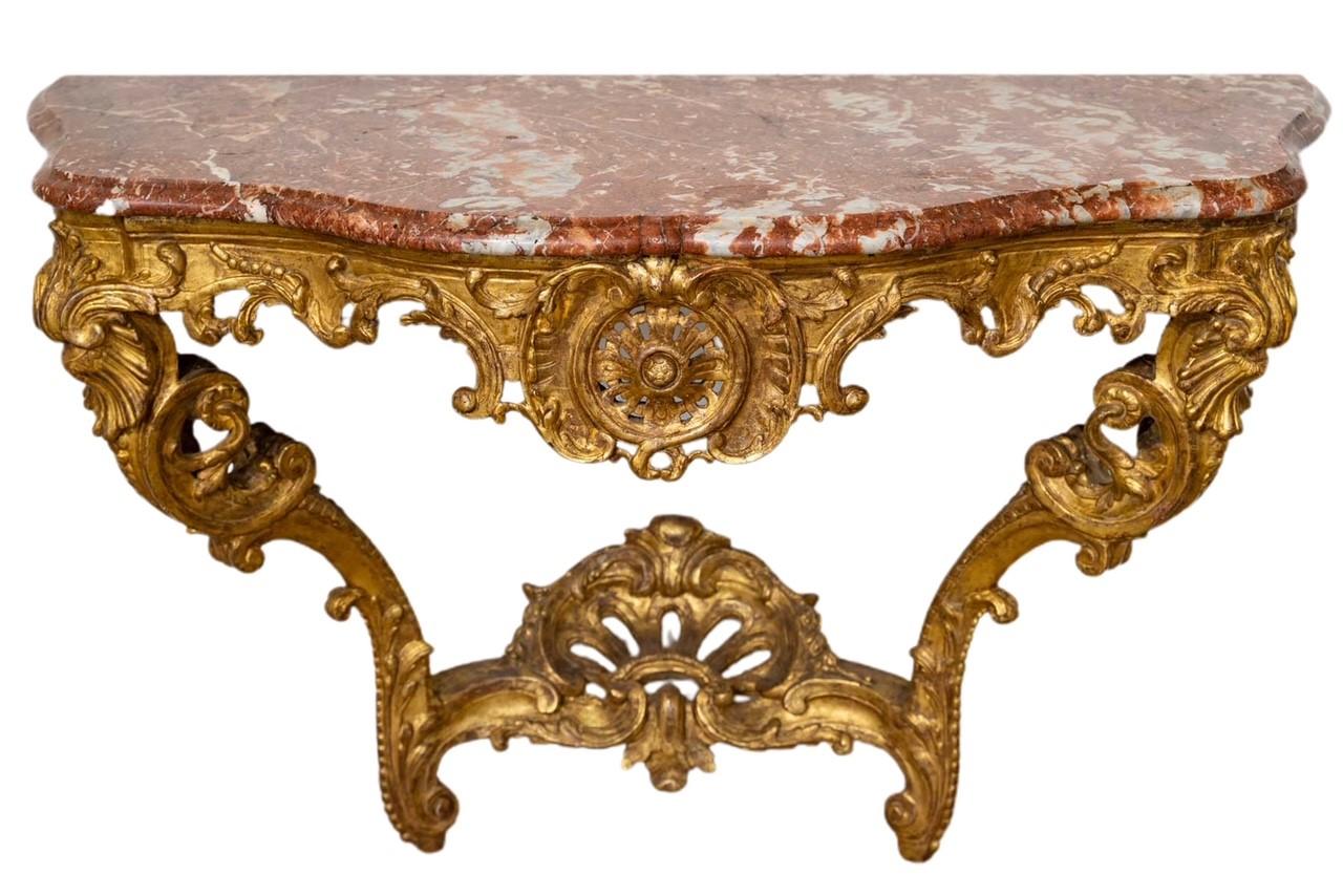 An important carved and gilded wood console table with marble top, Regency period, 18th century.

A Regency period console table, 18th century, carved and gilded wood, marble top.
H: 86cm, W: 134cm, D: 59cm