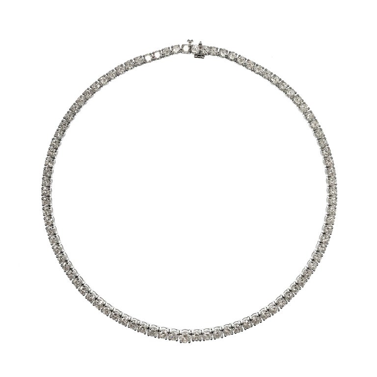 18 Karat White Gold Diamond Eternity Necklace, 28.77ctw. An exquisite necklace with ninety radiant round prong-set diamonds, graduate diamonds from 4.6 to 4.2mm and 3.8 to 4.0mm. Diamonds are VS1-VS2 excellent cut (G.I.A.) in clarity and F-G in