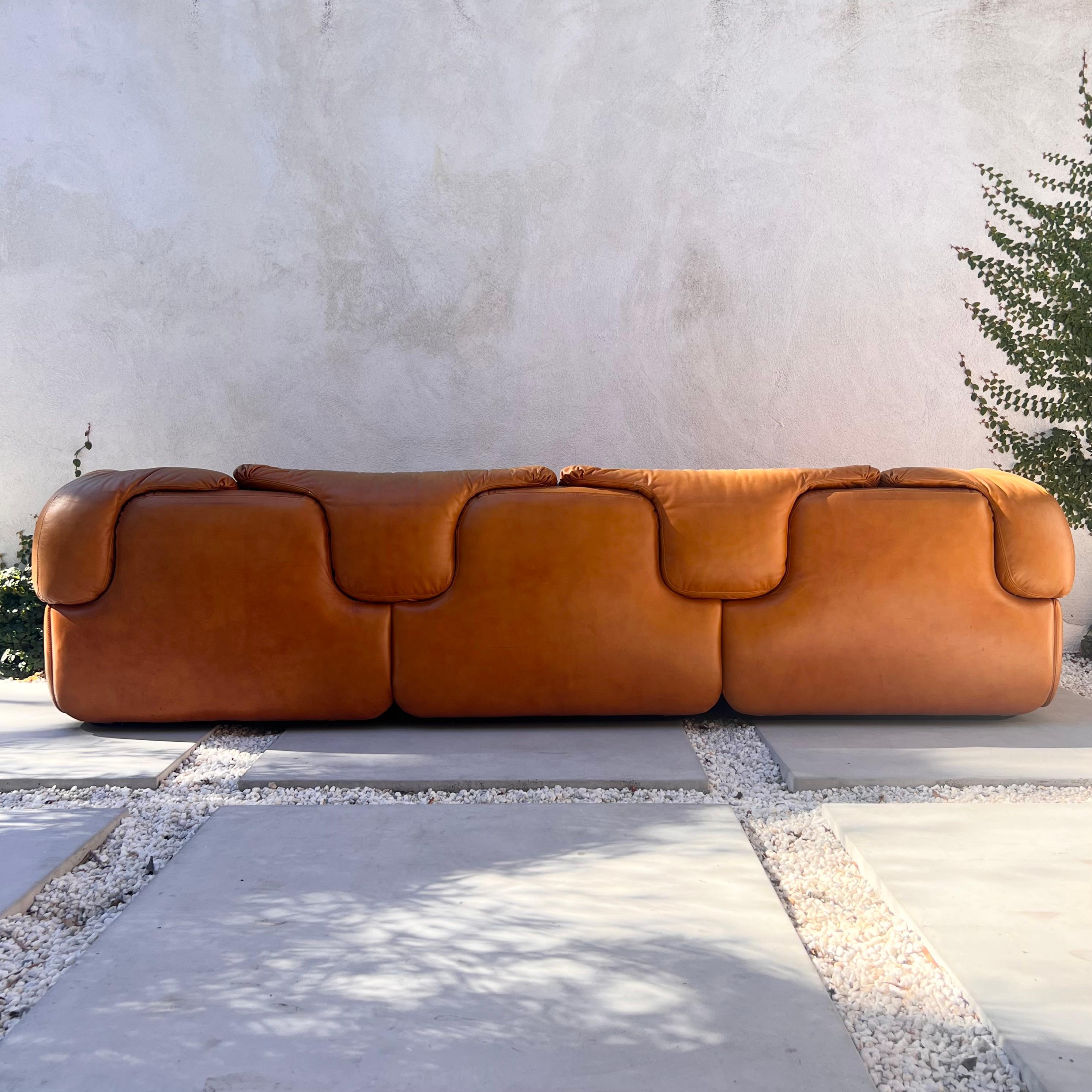 A vintage Italian « Confidential » 3-seater sofa by Alberto Roselli for Saporiti Italia, circa 1972. In cognac leather. Patina throughout and some significant wear but overall good condition. Pick up in LA or we ship worldwide; please don’t hesitate