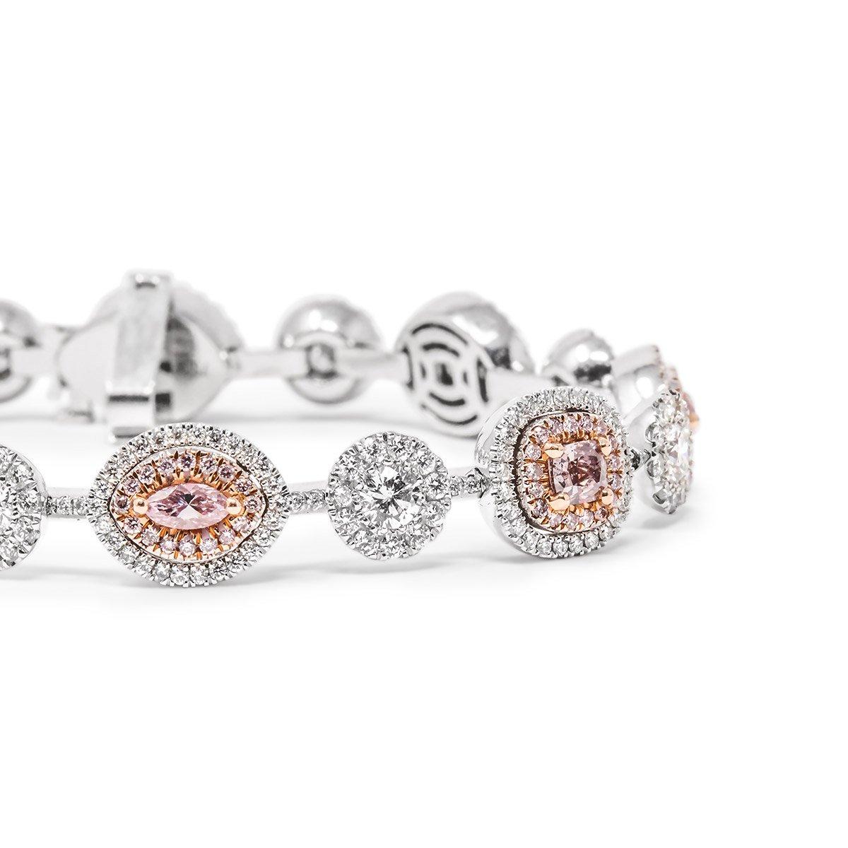 This diamond bracelet hosts 8 Fancy Pink GIA Certified Diamonds and 8 White Diamonds which are each accented by a diamond halo of round brilliant cut diamonds. This bracelet is 7.06