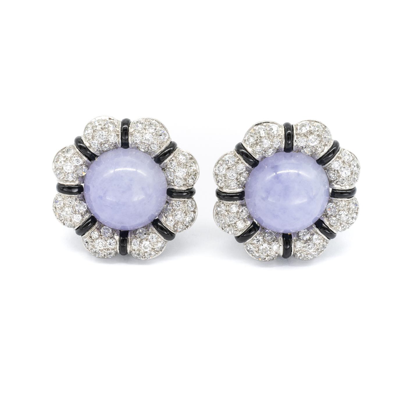 A pair of lavender jade and diamond earrings, with a flower shaped design, with a pavé set, old-cut diamond and black onyx surround, mounted in platinum, with collapsible posts and clip fittings.