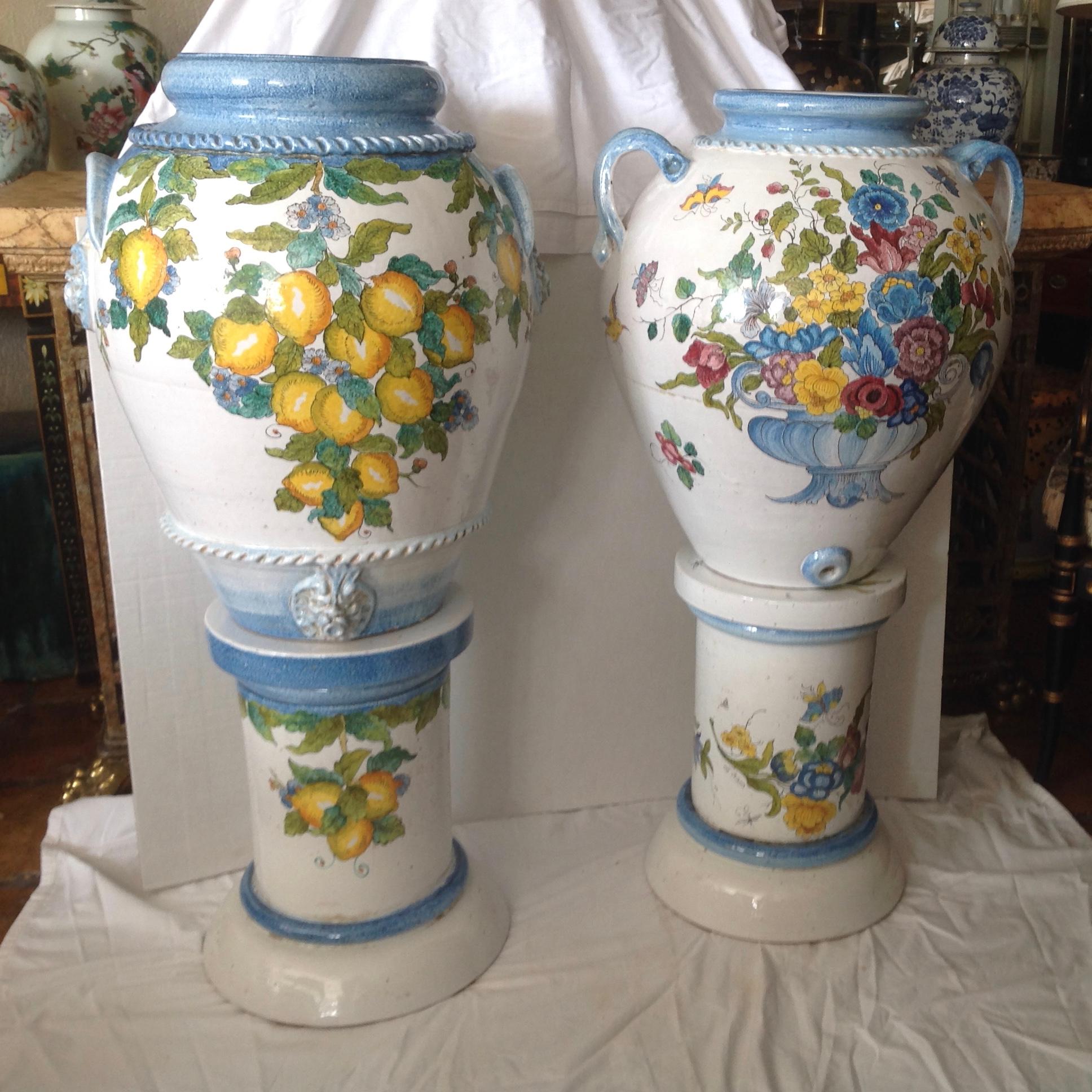 Dramatic in scale: Hand painted urns - superbly fashioned in the Tuscan style - 
signed La Chimera. The pair with urn form and details - perfectly complementary.