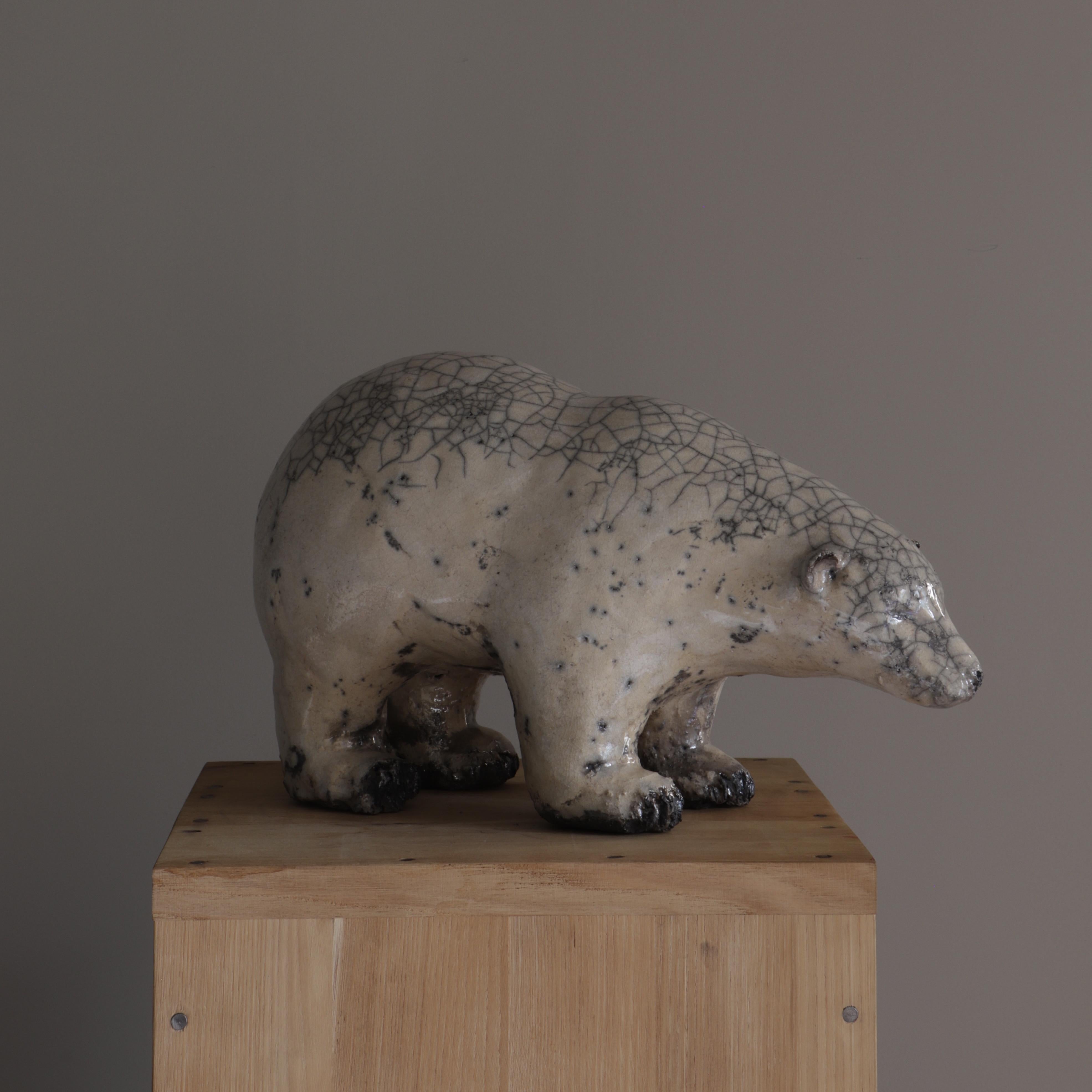 Joanna Hair created this Bear using the Raku technique consisting of smoking the piece in wood chips or sawdust, giving it this cracked aspect.