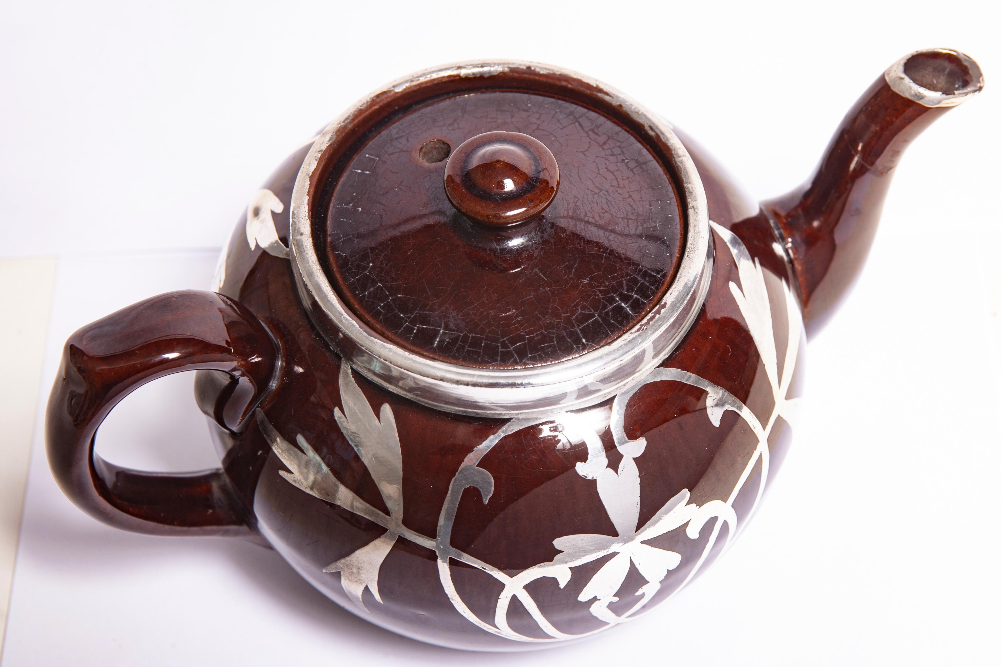 English Teapot/Sterling Overlay, This iconic teapot, has been decorated with sterling in a leaf & flower motif. Marked 