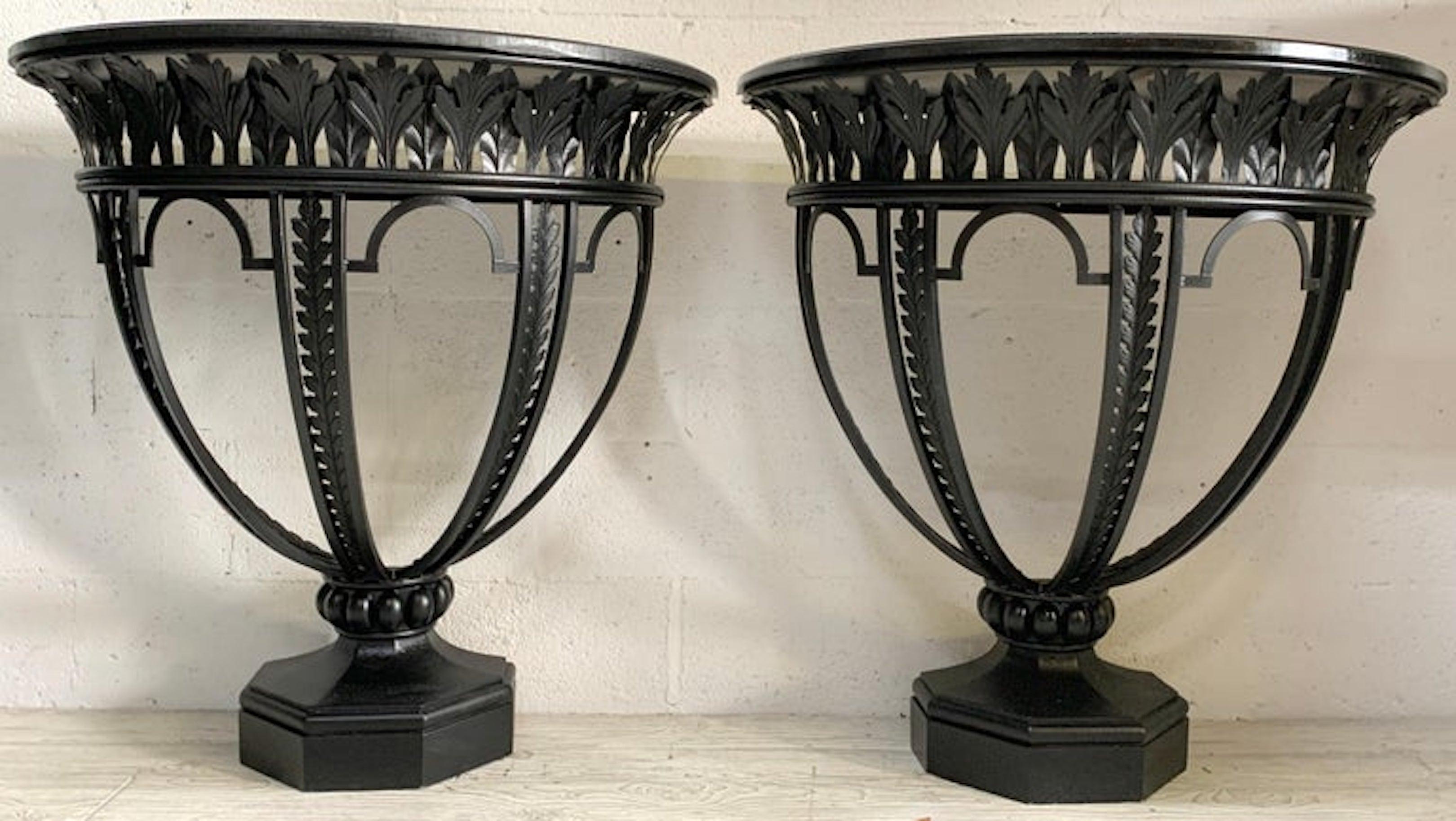Pair of Italian Neo-Classical wrought iron & wood consoles
Each one of demilune form raised on stylized acanthus pierced wrought iron urn motif base, resting on a 8