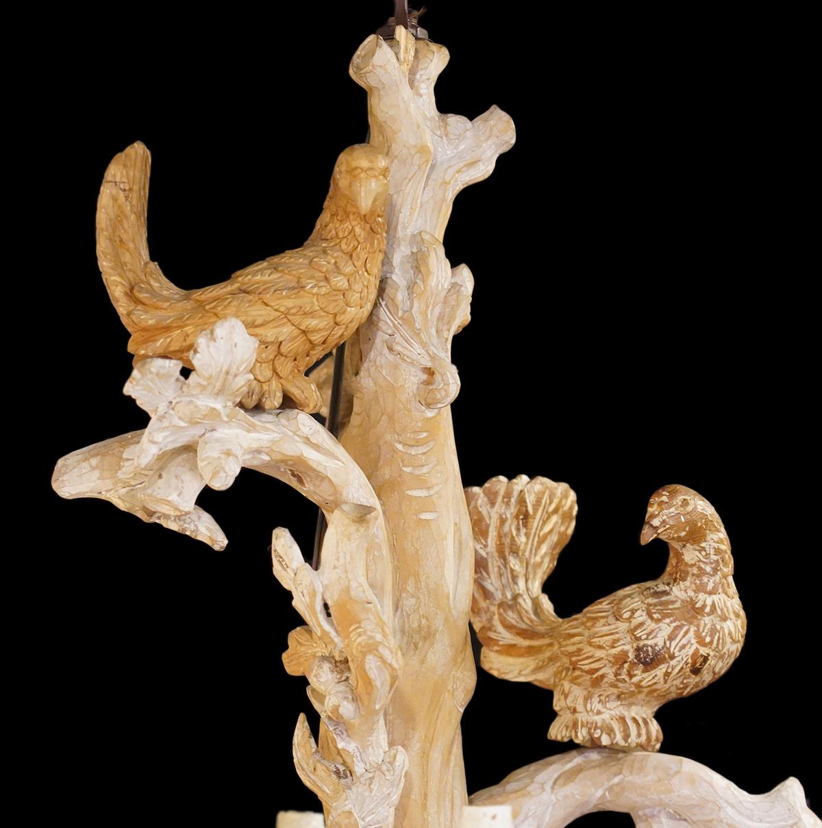 48 inches tall and elaborately carved in the natural style with branches, oak leaves, acorns etc. this striking Italian chandelier also features two doves romantically perched on the upper branches. The blonde wood is attractively washed with chalky