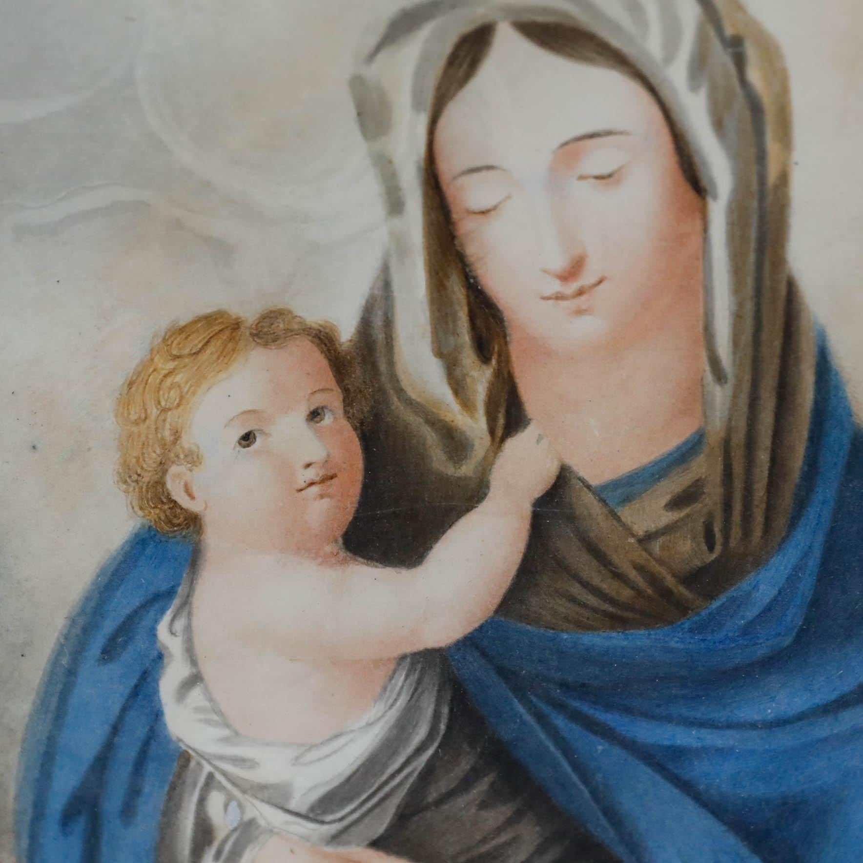 Fino retrato en acuarela de principios del siglo XIX que representa a la Virgen con su hijo. Presentado en un bello marco del siglo XIX con molduras foliadas y acantos en las esquinas. Sin firmar. Sobre el papel.