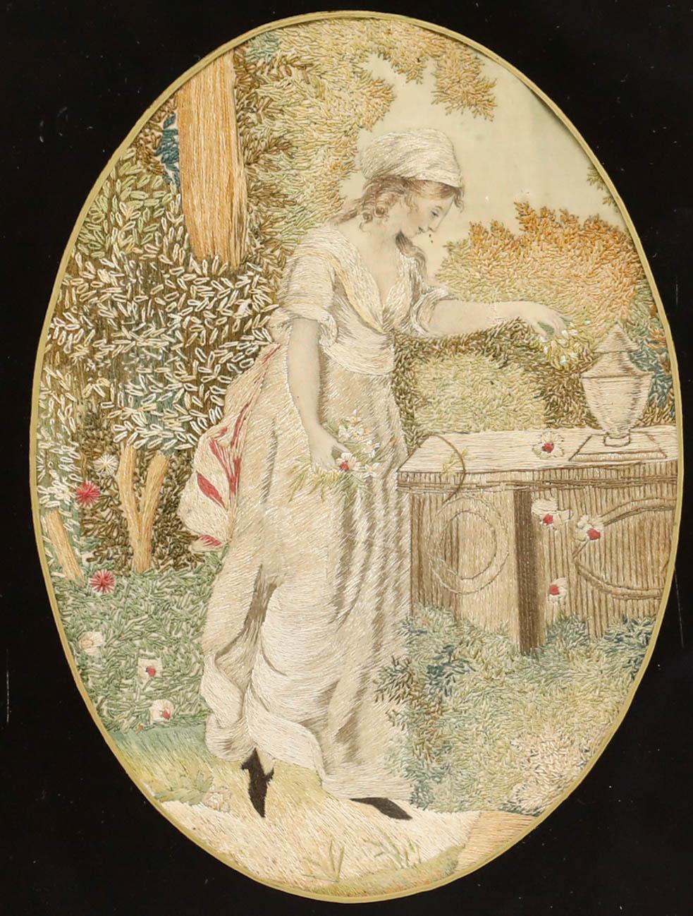 This detailed embroidery depicts a woman picking flowers in a garden. Presented in a gilt frame with decorative foliate corners and a verre églomisé mount. Acquired with a companion work, also listed on our website. On silk. 