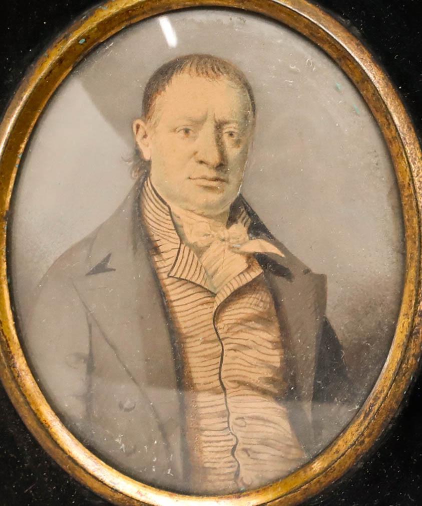 A very fine early 19th-century watercolour portrait of a gentleman wearing a striped waistcoat and dark overcoat. Finely painted with great attention given to the facial features. Well presented in a papier-mâché frame. Unsigned. On paper.
