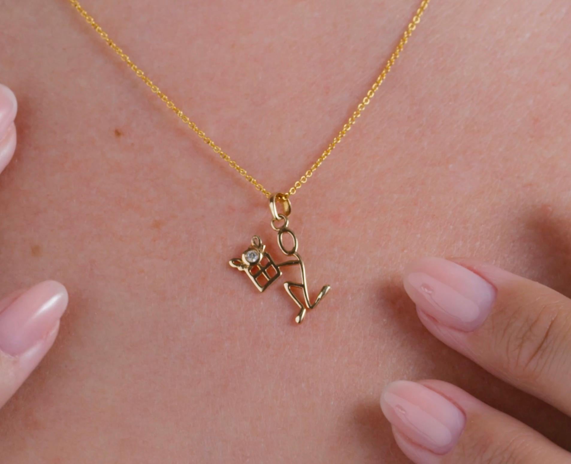 0.05 Carat Diamond Yellow Gold Stick Figure Presenting Gift Pendant Necklace.

This pendant necklace was handmade with 18-karat yellow gold. It features a 0.05-carat diamond depicted as the center of a bow atop a present. This pendant is on an