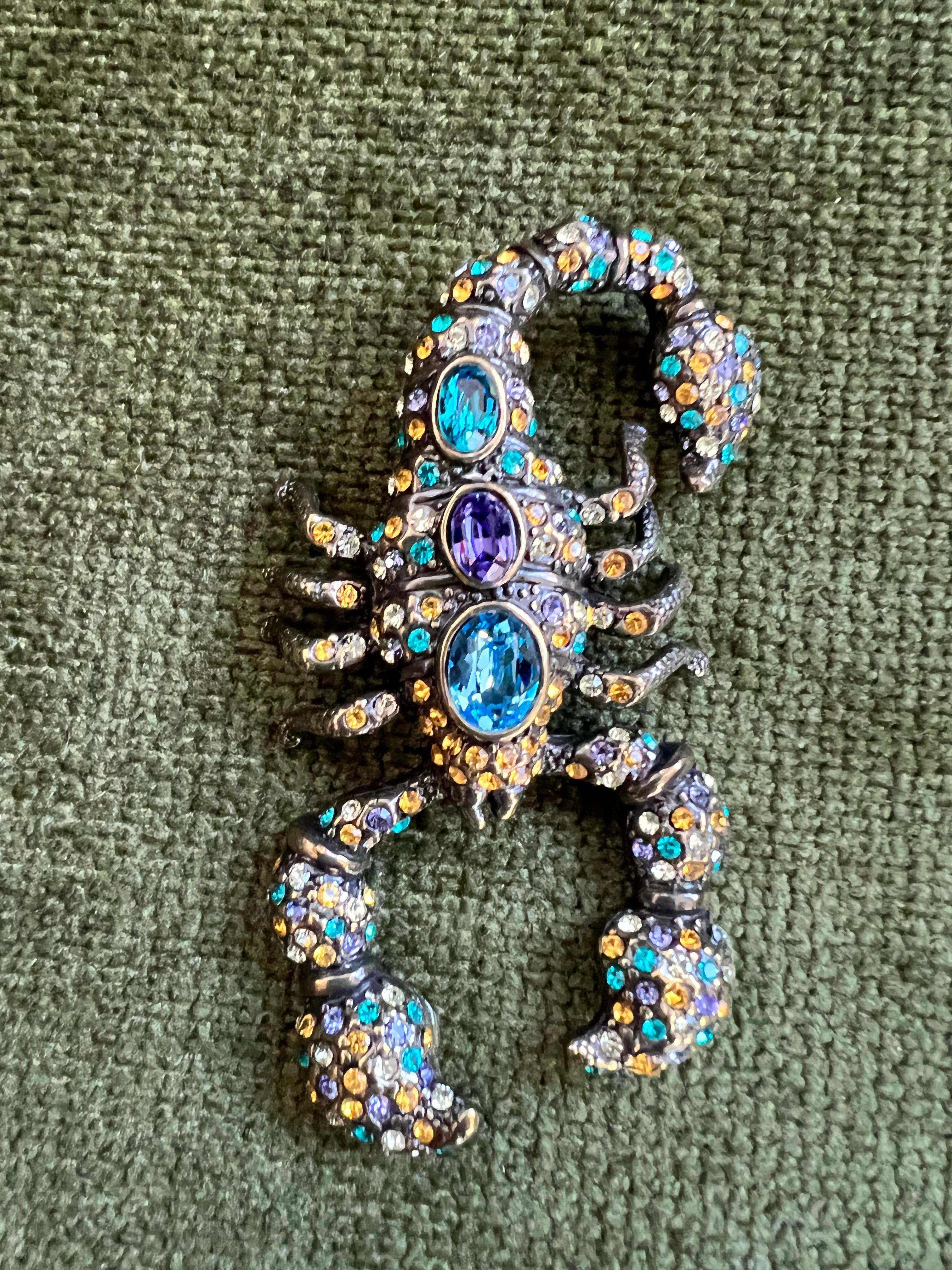 “007 Whisky Scorpion” brooch
Bochic red carpet bijoux jewlery, from the “IKON” private collection. 
Inspired by James Bond drinking game in “Sky Fall “ the colors chosen from the sunset at fethiye beach turkey.
Aqua blue, topaz blue, honey gold,