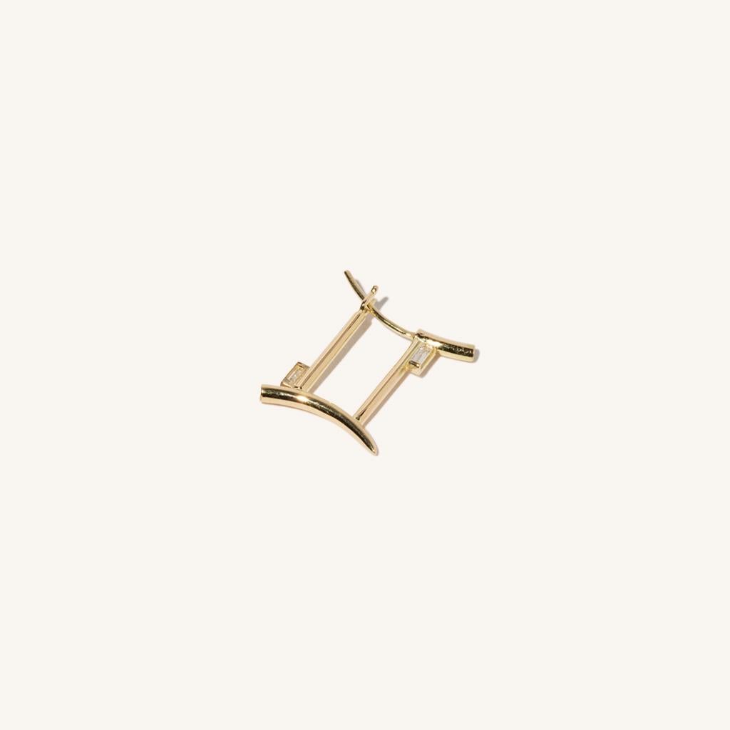 Zodiac inspired items are special items that have long been said to be auspicious. MILAMORE's zodiac motif earrings take form in 18 kARAT yellow gold accented with two sparkling baguette-cut diamonds and finished in an abstract shape that looks good