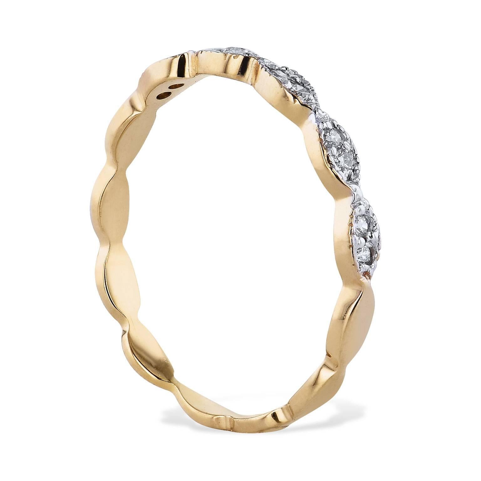 Interlocking ovals featuring 0.08 carat of diamond evoke a sense of movement in this 14 karat yellow gold diamond band (size 6.5).