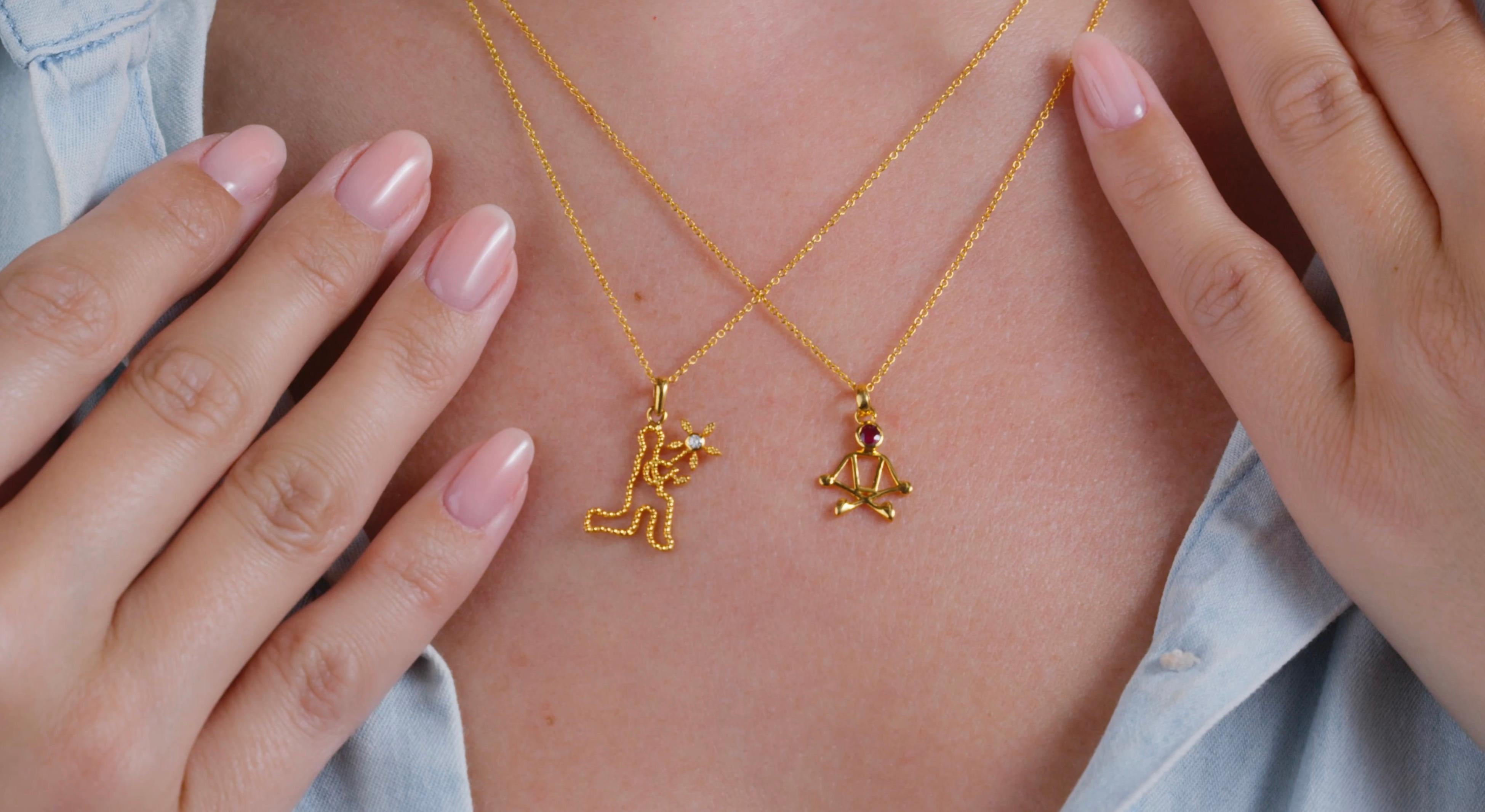 0.10 Carat Ruby 18 Karat Yellow Gold Stick Figure Meditating Necklace.

This pendant necklace was handmade with 18-karat yellow gold. It features a 0.10-carat ruby. This pendant is on an 18-inch chain necklace with a lobster clasp. The pendant