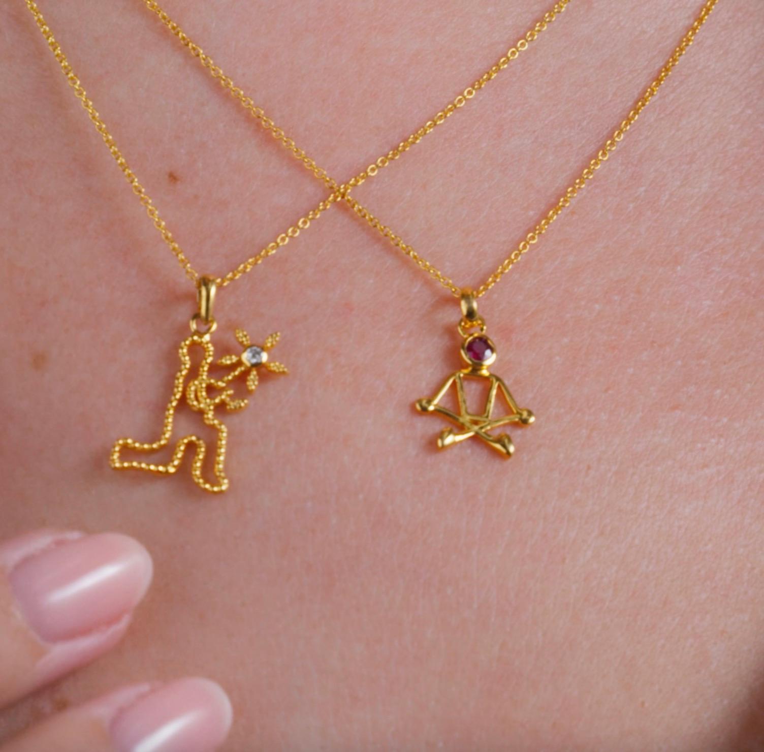 0.10 Carat Ruby 18 Karat Yellow Gold Stick Figure Meditating Necklace In New Condition For Sale In Woodstock, GA