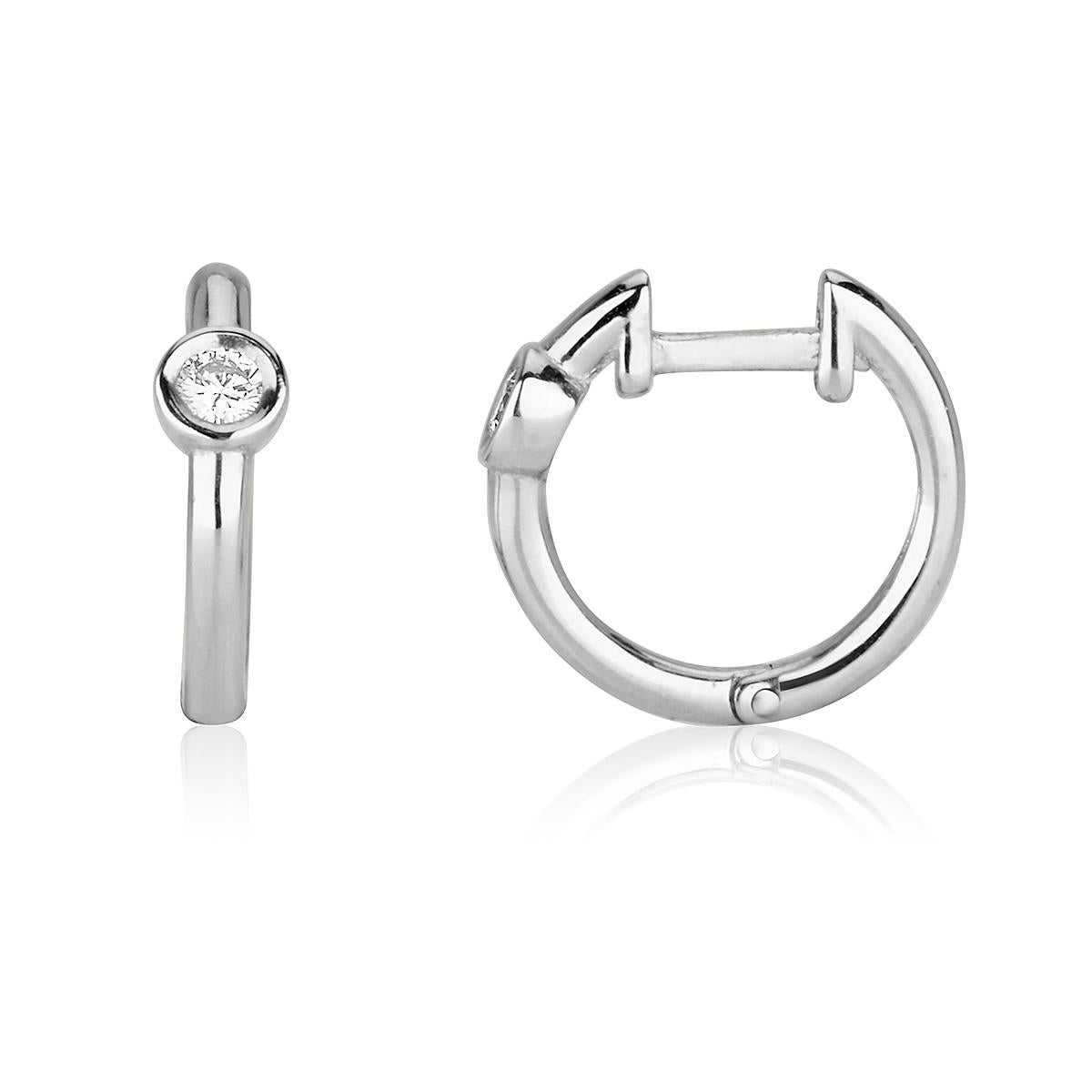 0.10 Carat Diamond Huggie Hoop Earrings in 14K White Gold - Shlomit Rogel

A staple in every woman's jewelry collection - classic diamond hoop earrings. Handcrafted from 14k white gold and bezel set with a genuine 0.05 carat diamond, these hoop