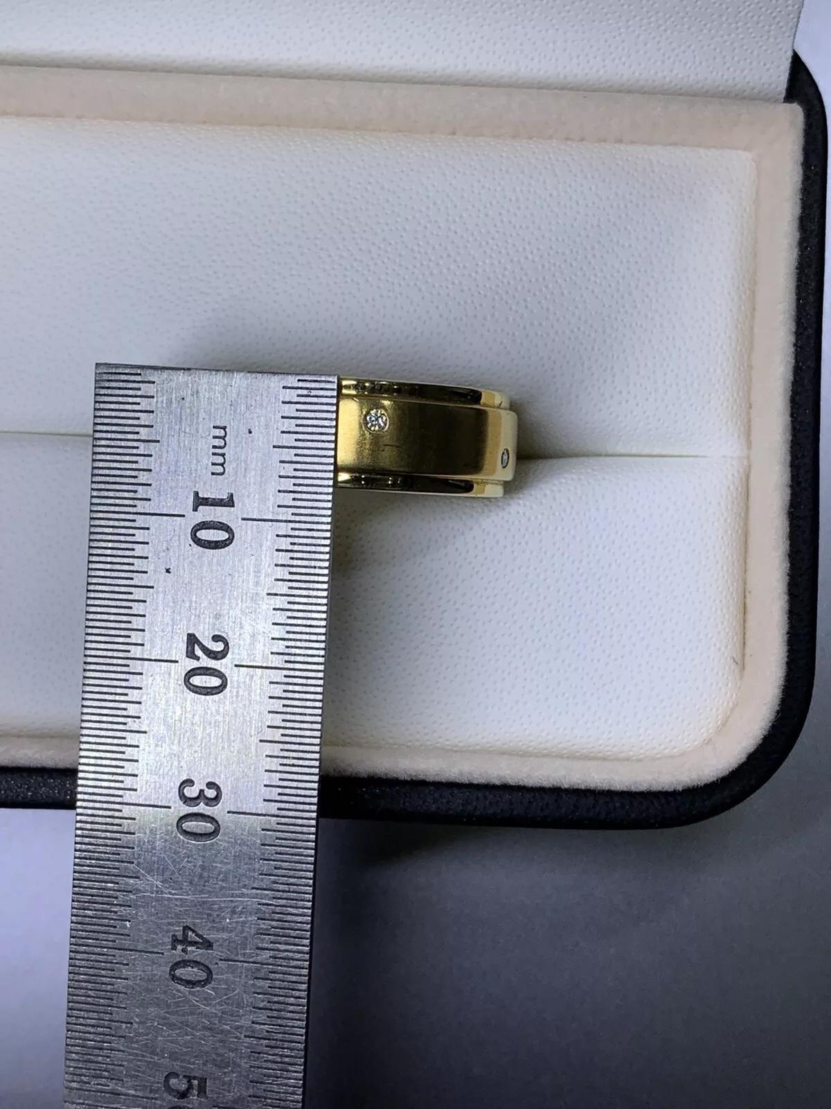 This 18ct yellow gold men's wedding ring is a stunning piece of jewellery that features a natural round diamond with a carat weight of 0.10. The band is 7.5mm wide, with a flush setting style and a matte finish, making it a unique and stylish option