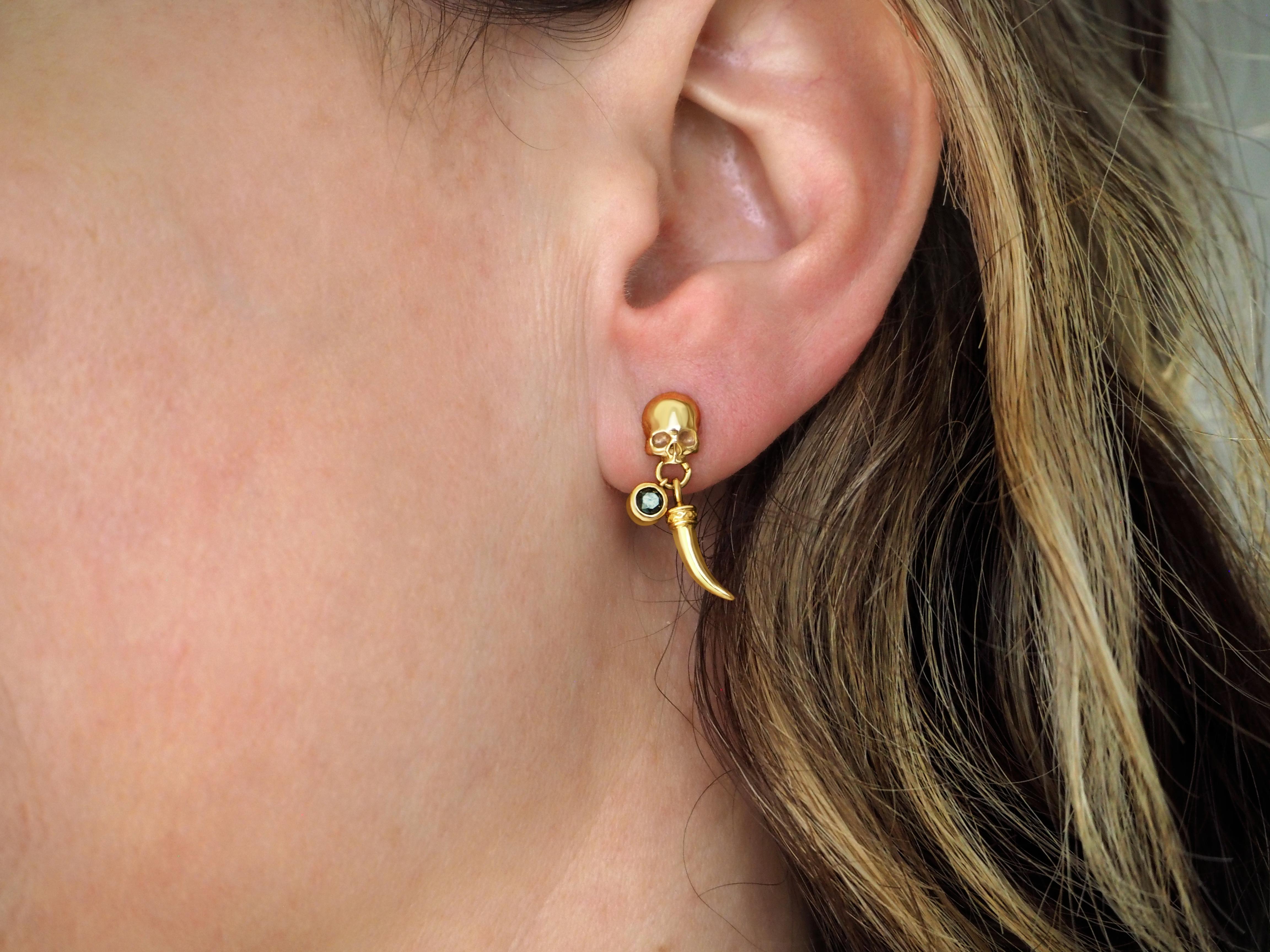 14ct Gold Skull Earring with Emerald & Tusk 

This custom single-drop earring features a shiny dimensional skull on the top, giving it an ethereal gothic look, beautifully handcrafted with attention to detail. This striking 3D skull suspends a