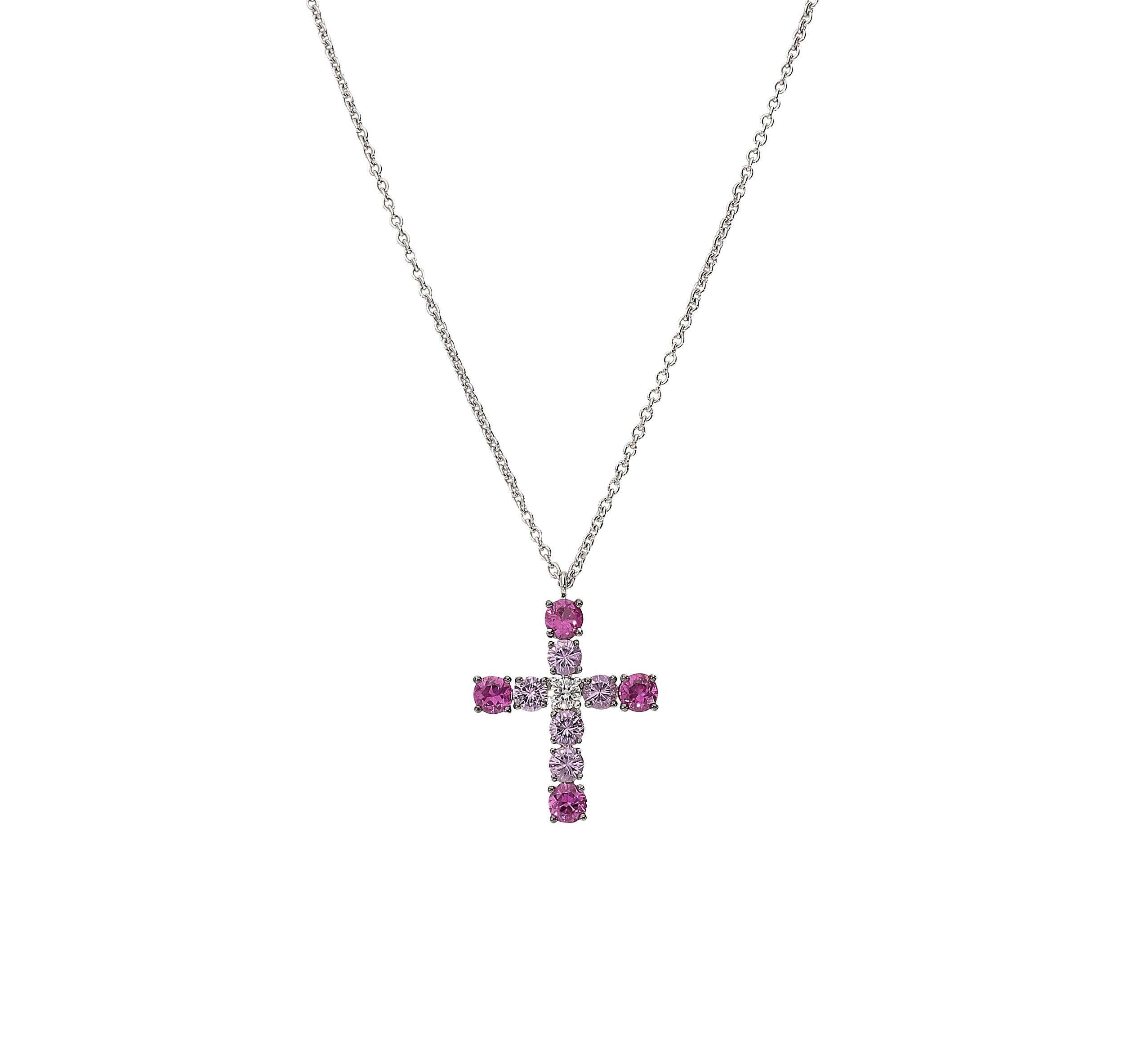 Sophisticated cross with 42 centimeters chain in 18kt white gold for a grand total of 5,60 grams.
At the apexes there are 4 wonderful rubies with dark fuchsia nuance for 0,95 carat, then 5 pink sapphires for 0,96 carat and a central white round