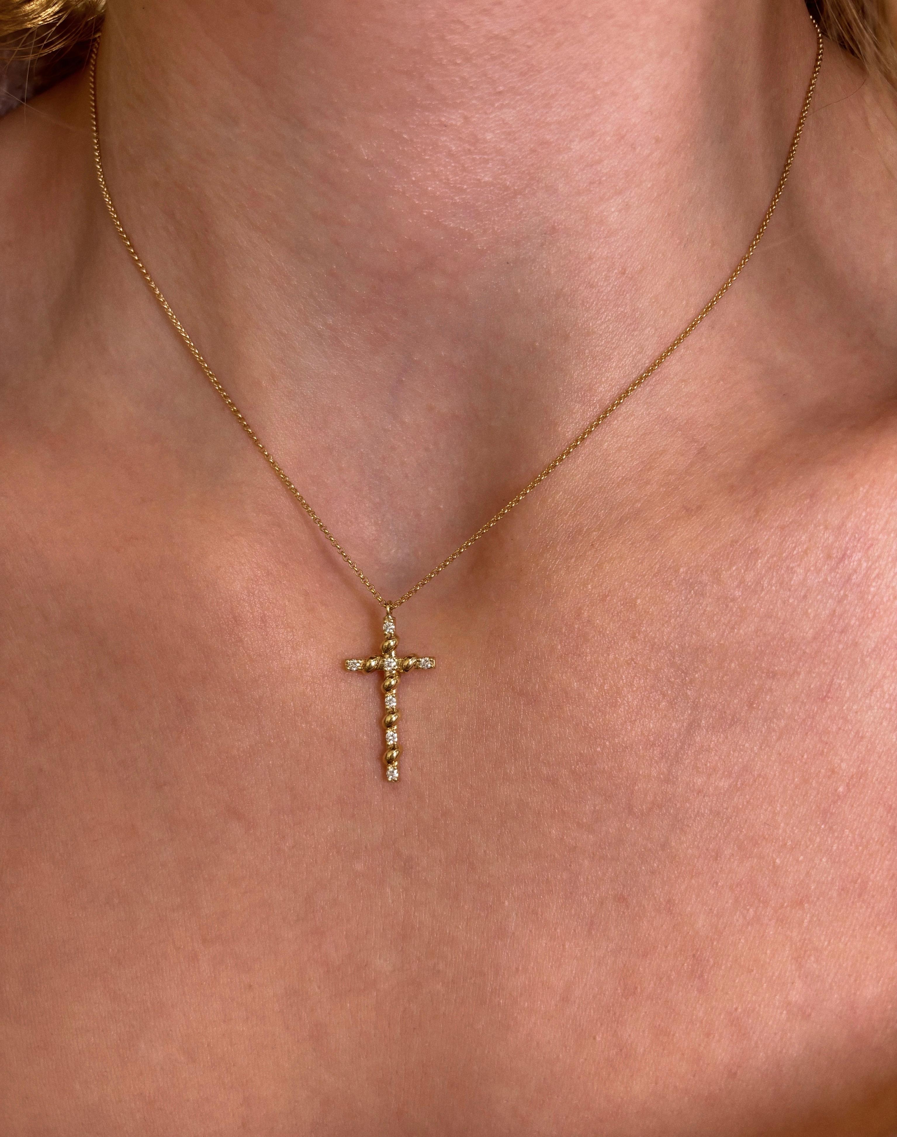The Rope Diamond Cross Necklace is crafted in 18 Karat Yellow Gold. It has a rope-like detail and is traced with seven natural round brilliant cut diamonds, with total carat weight 0.11cts. The 18K gold chain has a total length of 40cm/16inch and is
