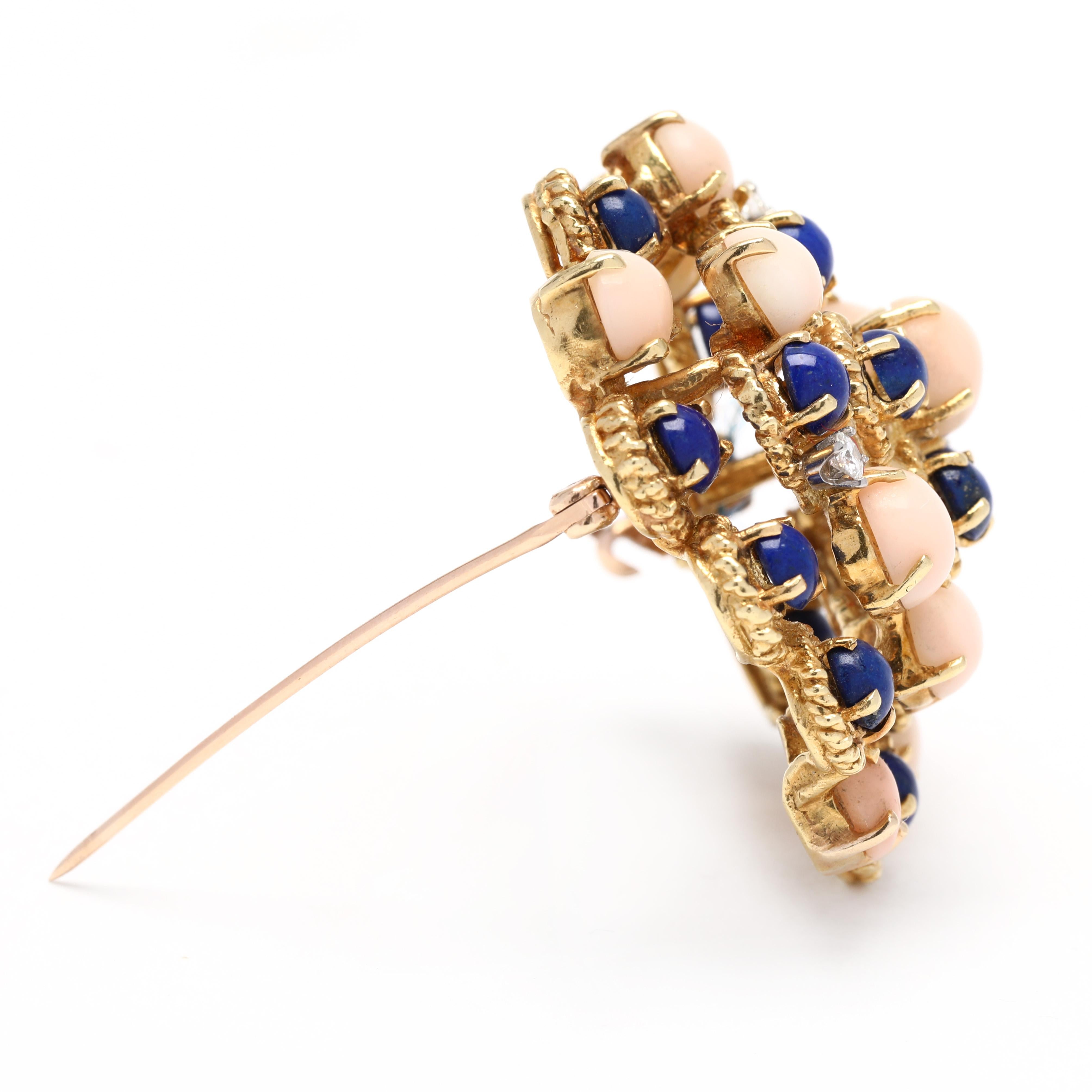 This one-of-a-kind 0.12ctw diamond, coral and lapis signed brooch features 18K yellow gold. Crafted with expert attention to detail, this large gemstone brooch sparkles with a unique luminosity. Perfectly sized to draw attention to the face and