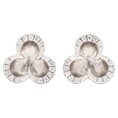 Clous d'oreilles fleur en or blanc 14 carats avec diamants 0,12 carat