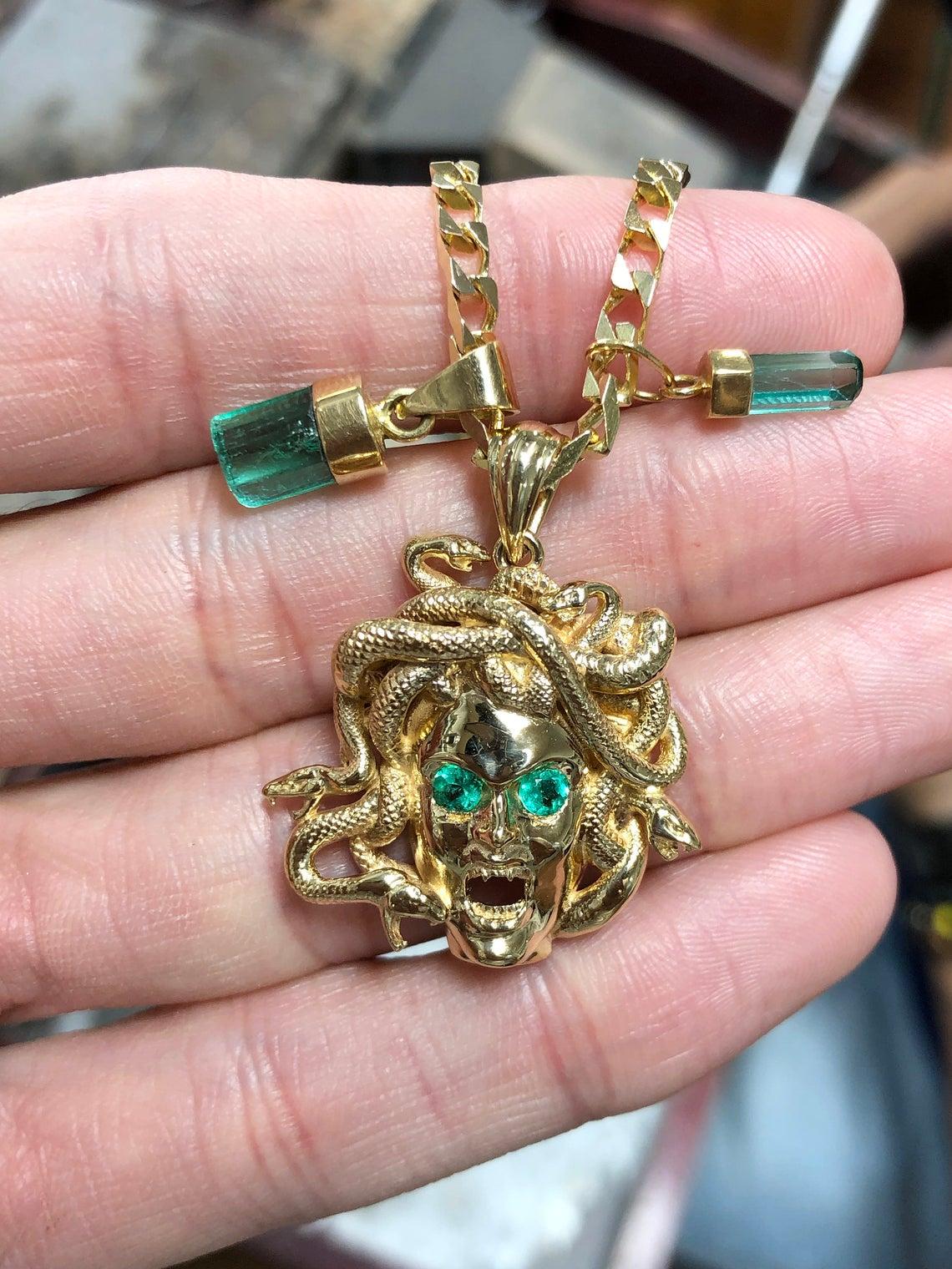 Stunning Medusa head handcrafted in precious 18K yellow gold with earth mined beautiful quality green emeralds. (Please contact us for the chain as it is sold separately) Pendant only included.

Setting Material: 18K Yellow Gold
Approx Gold Weight: