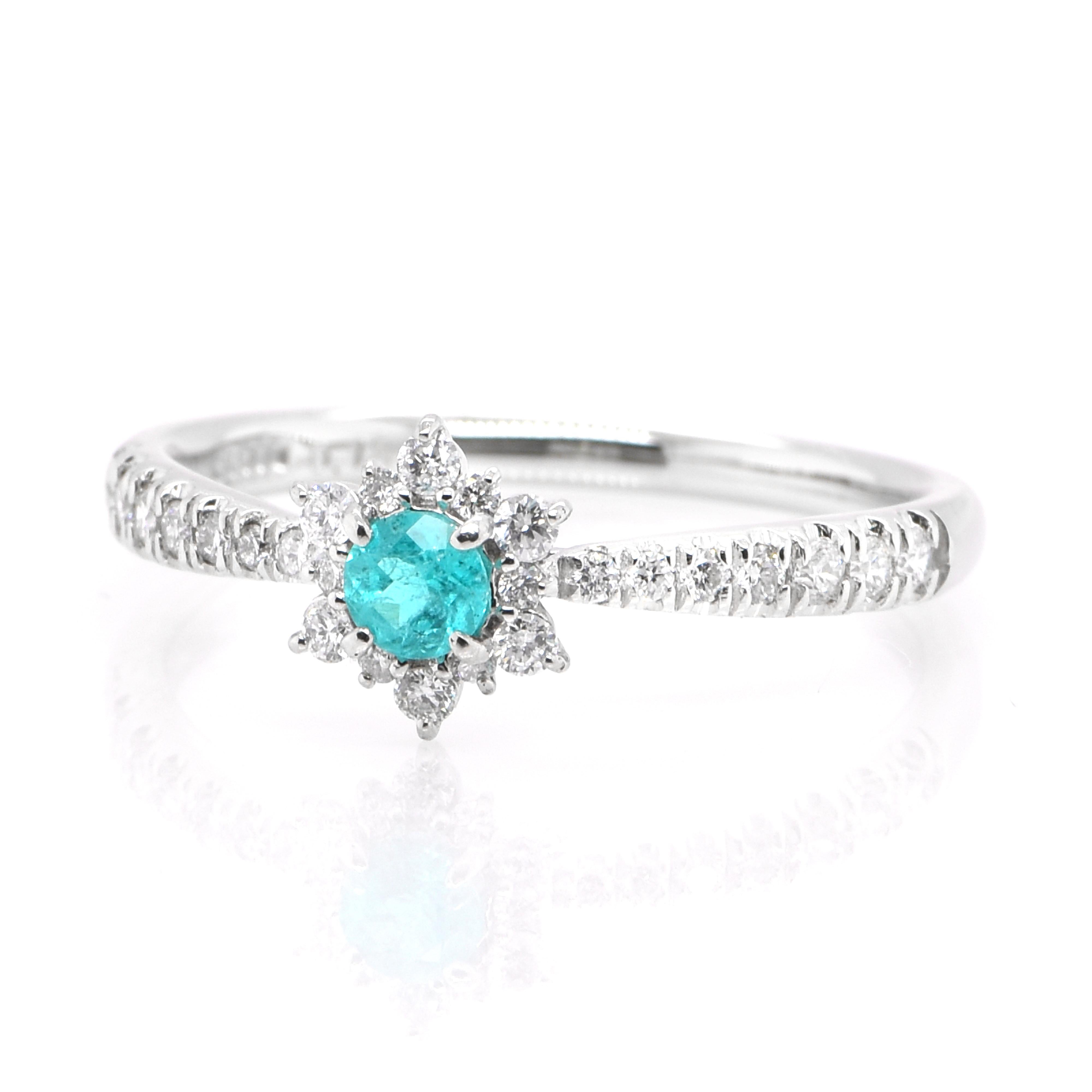 A beautiful ring featuring a 0.13 Carat Natural Brazilian Paraiba Tourmaline and 0.22 Carats of Diamond Accents set in Platinum. Paraiba Tourmalines were only discovered 30 years ago in the Brazilian state of the same name- Paraiba. Since then they