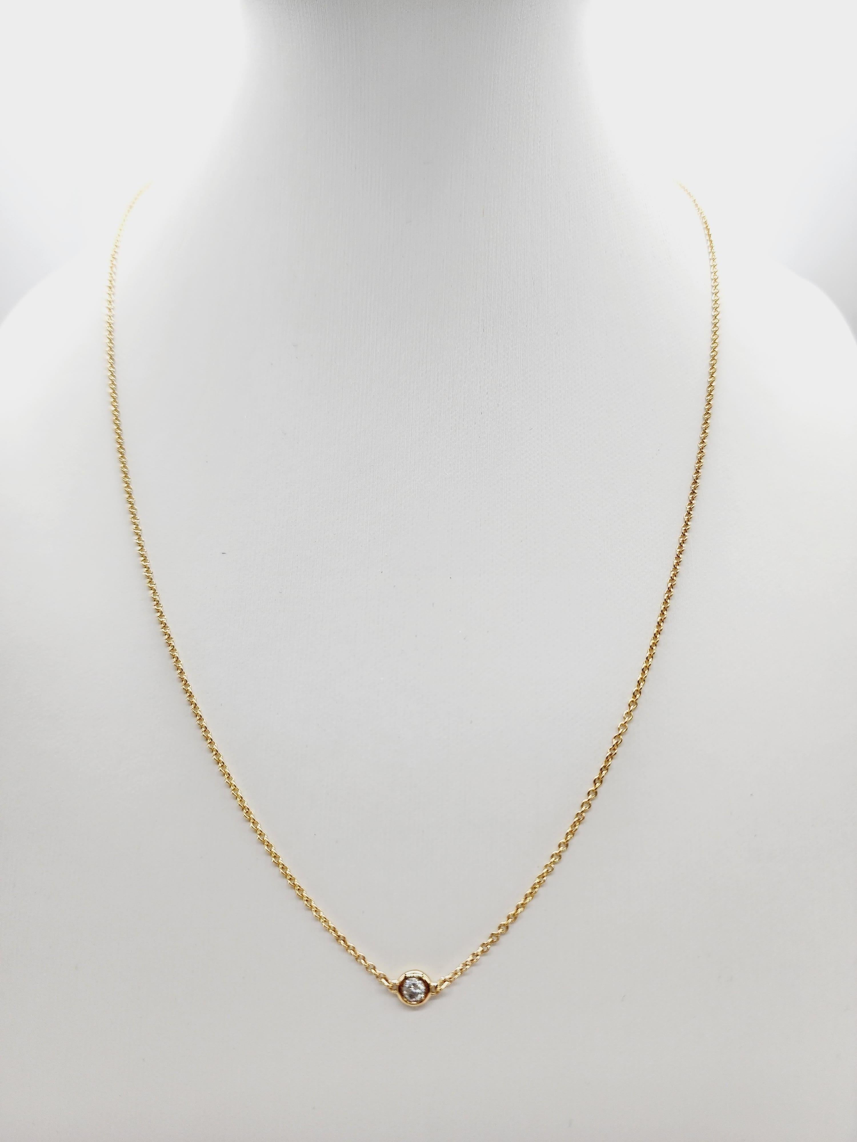 This beautiful Single Station Diamond by the Yard Necklace features a stunning natural diamond set in Italian-made 14K yellow gold. With a total weight of 0.13 carats, the necklace showcases a shiny, radiant diamond that adds a touch of elegance to