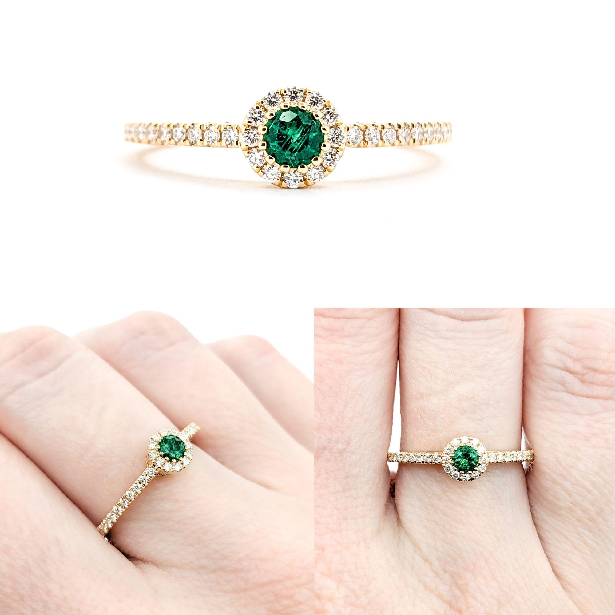 0.13ct green Emerald and Diamond Halo in 18k Yellow Gold

This exquisite ring features a 0.13ct green Emerald centerpiece surrounded by 0.22ctw of round Diamonds. The Diamonds are of SI-I clarity and have a near colorless white hue, which