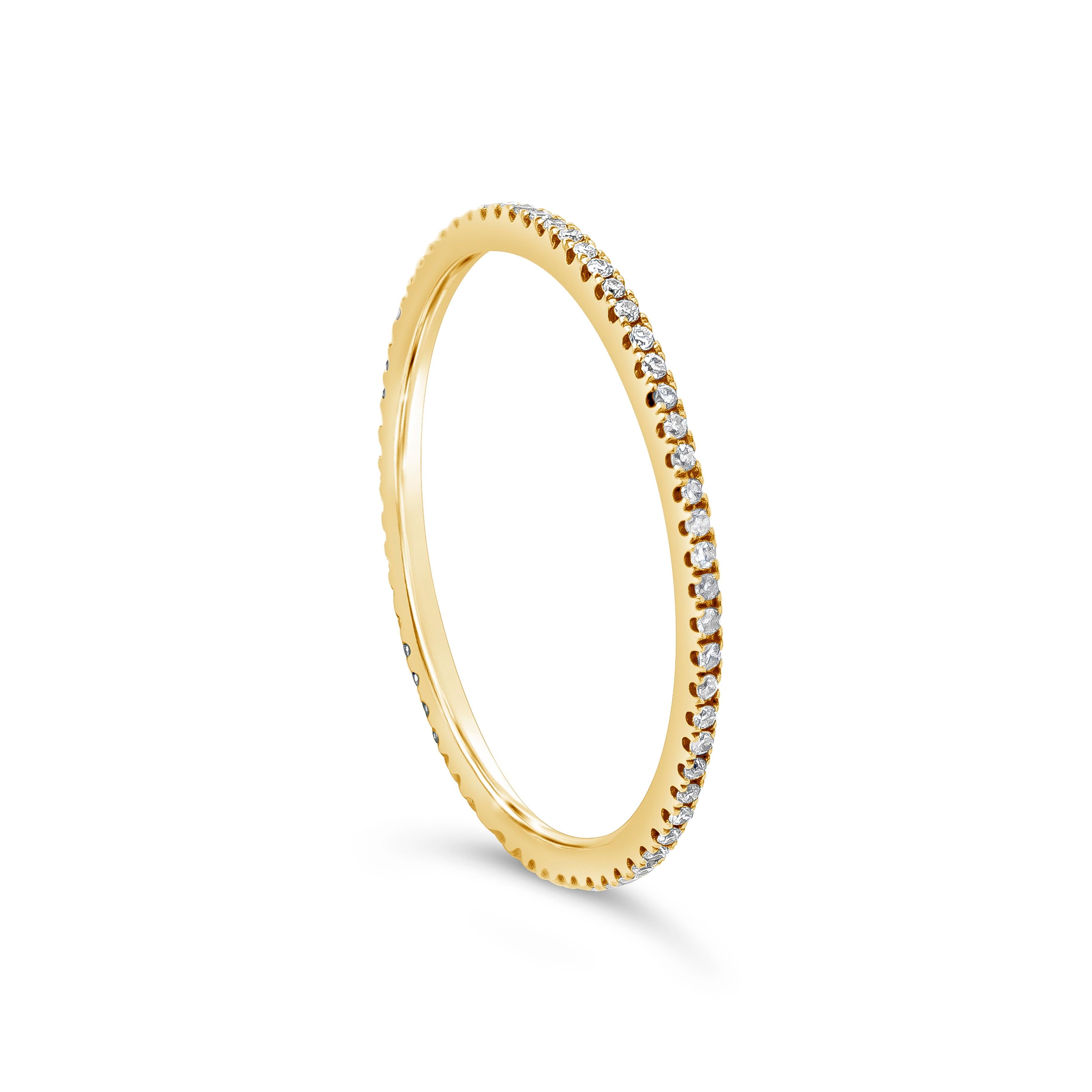 A simple eternity wedding band, showcasing a row of round melee diamonds weighing 0.14 carat total. Made with 18K yellow gold. Size 7.25 US. Perfect as a spacer between an engagement ring and a wedding band.

Roman Malakov is a custom house,