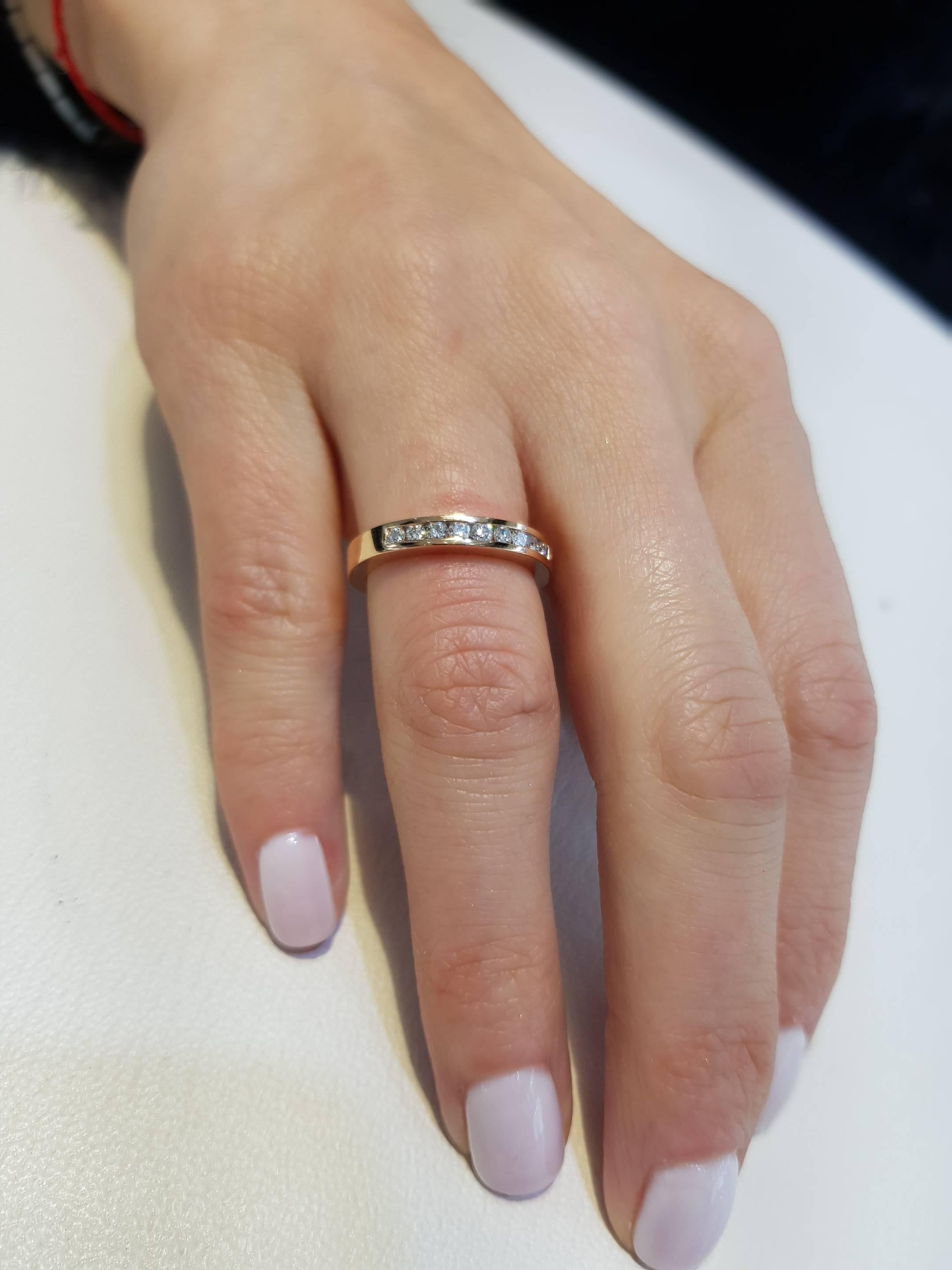 This channel set 18 Karat Rose Gold half Eternity ring is an exquisite addition to our collection. A sparkling array of nine H-SI1 Round Brilliant Diamonds for a classic and iconic look. This ring has a total diamond weight of 0.15 Carats, the