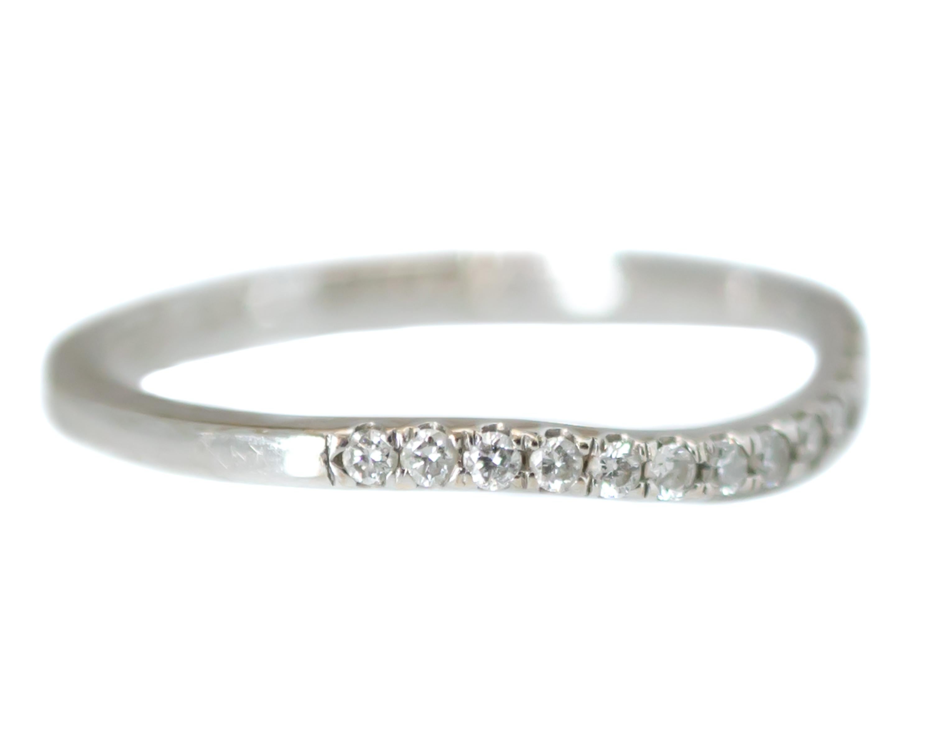 Curved Wedding Band - 18 Karat White Gold, Diamonds

Features: 
0.15 carat total Round Brilliant Diamonds
18 Karat White Gold setting
Curved front to accommodate an engagement ring
Prong set stones
1.5 millimeter wide band
2 millimeters finger to