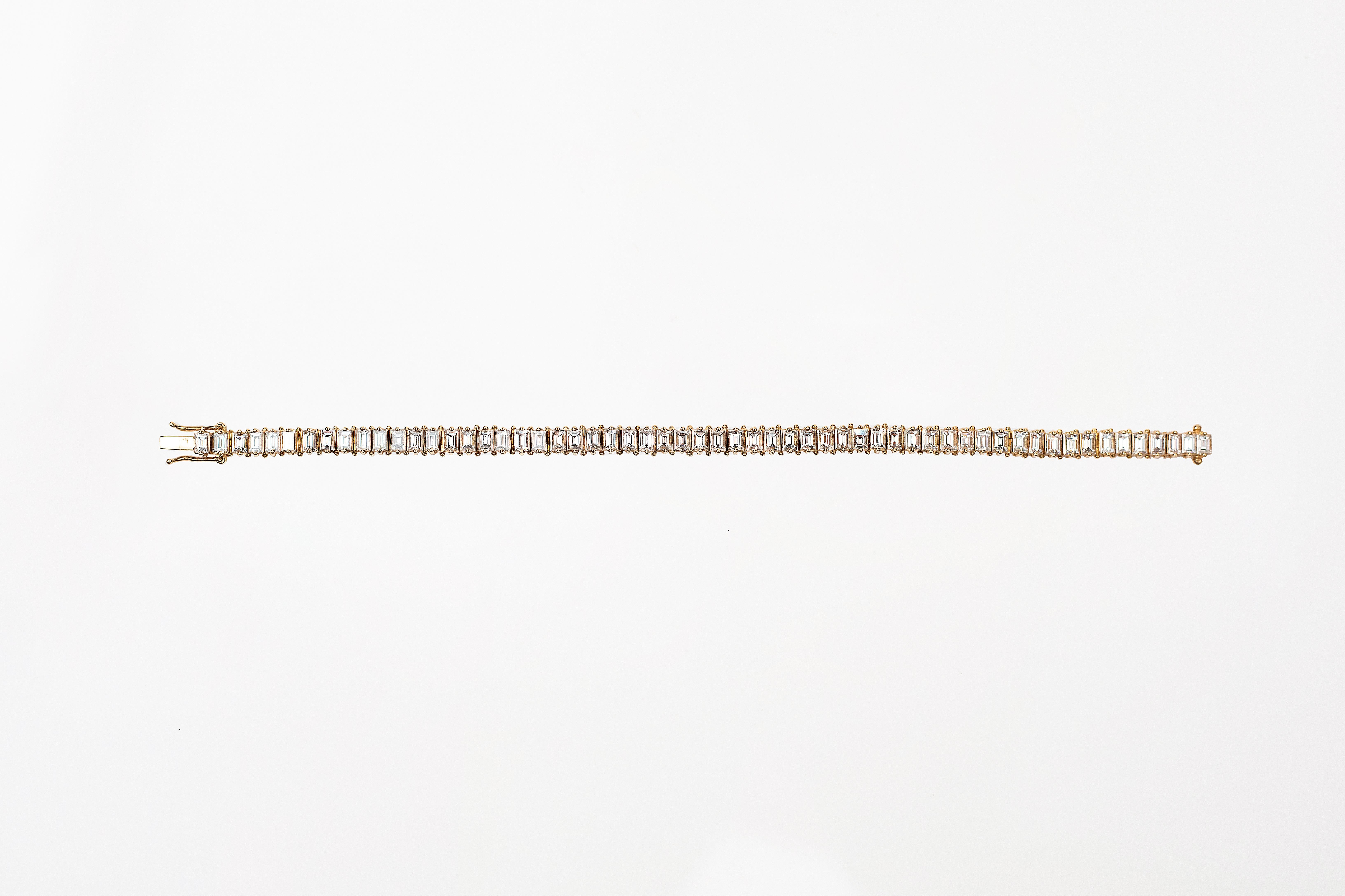 Handcrafted Tennis Bracelet in 18K Yellow Gold Studded with 0.15 Pointer Baguette Shape Diamond.
Gold Weight - 16.730 gms
Diamond Clarity - VS
Diamond Colour - G
