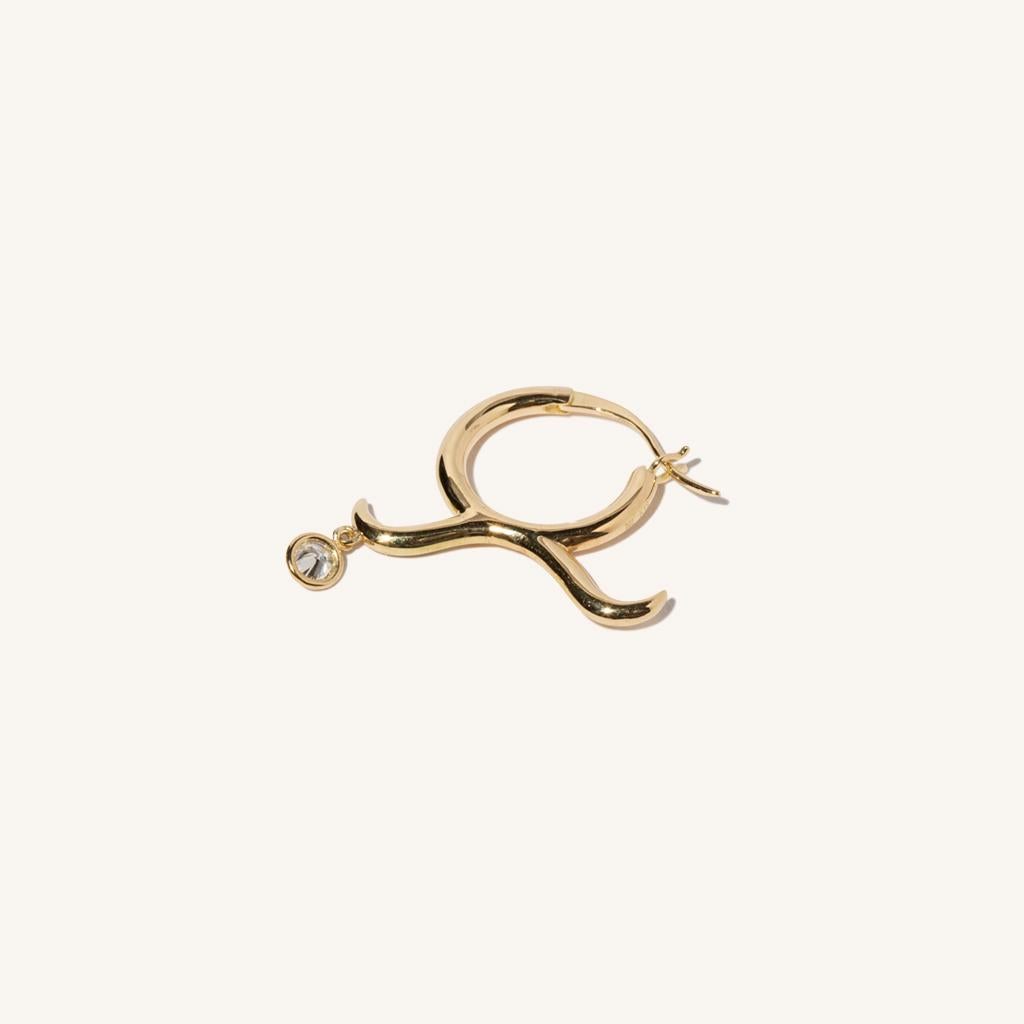 Zodiac inspired items are special items that have long been said to be auspicious. MILAMORE's zodiac motif earrings take form in 18 Karat yellow gold accented with a single, sparkling diamond and finished in an abstract shape that looks good on