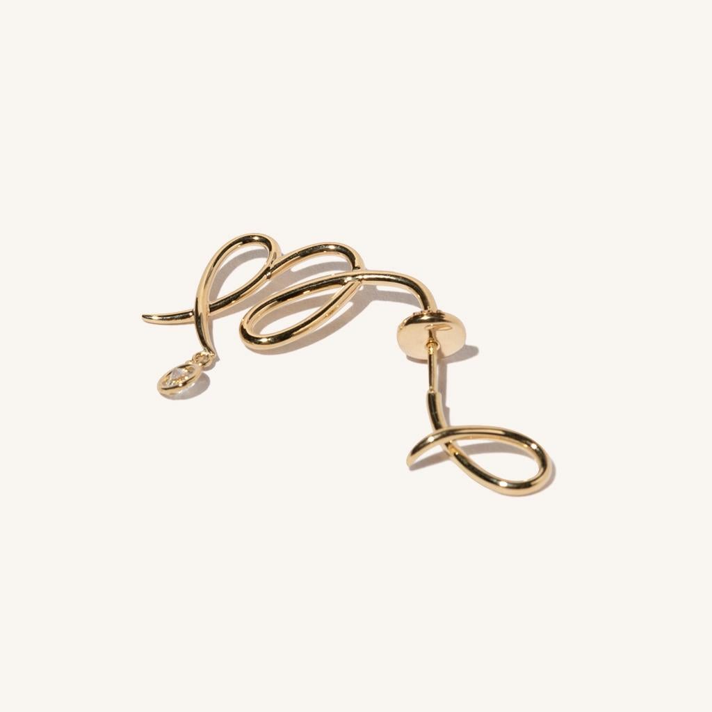 Zodiac inspired items are special items that have long been said to be auspicious. MILAMORE's zodiac motif earrings take form in 18 karat yellow gold accented with a single, sparkling diamond and finished in an abstract shape that looks good on