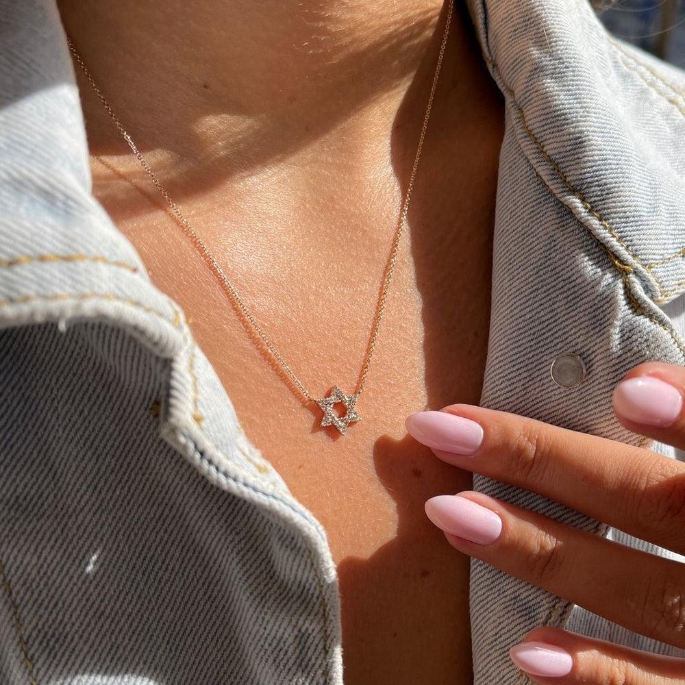 0.18 Carat Diamond Star of David Pendant Necklace in 14 Karat Rose Gold

Dazzling and elegantly timeless, this Star of David pendant is designed in 14k rose gold and accented with sparkling genuine white diamonds totaling 0.18 carat. A perfect