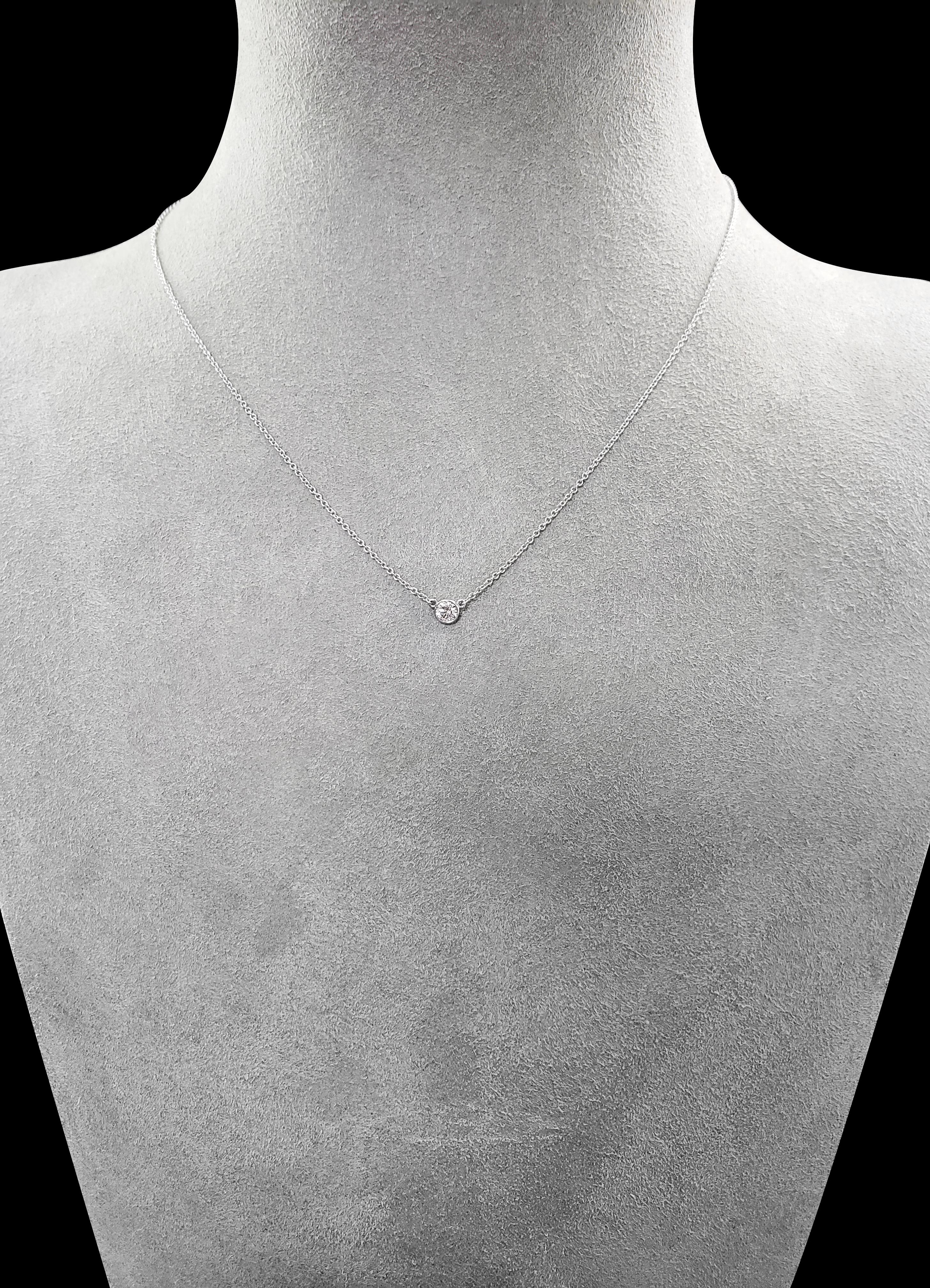 A simple and versatile solitaire pendant necklace showcasing a single 0.18 carat round diamond in a 14 karat white gold bezel. Attached to a 16 inch white gold chain. 

Style available in different price ranges. Prices are based on your selection of