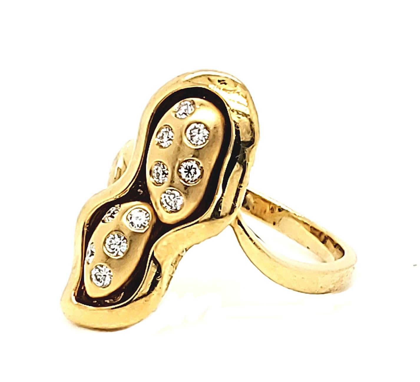 The 0.18 Carat White Diamond Peanut Design Yellow Gold Fashion Ring from Shimon's Creations features a peanut at the center of the ring made out of 18k yellow gold. To add some more sparkle to the ring there are 11 round cut white diamonds placed