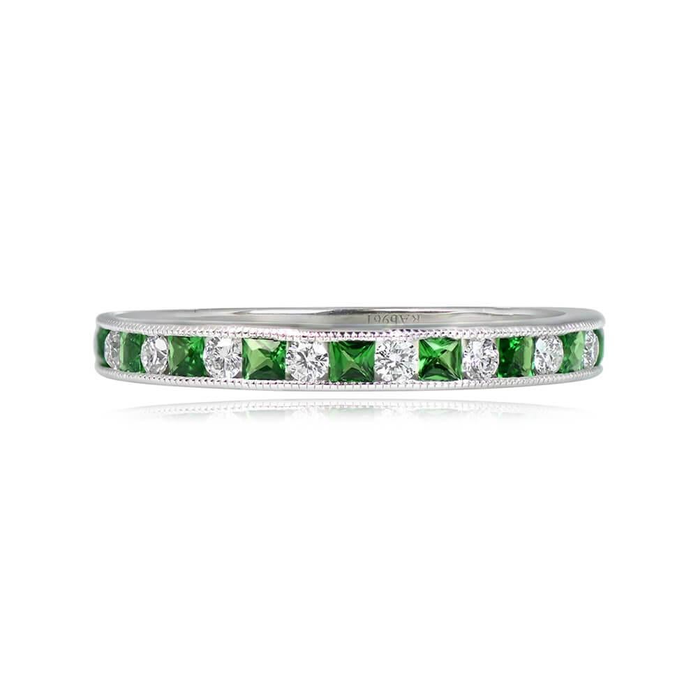 A stunning platinum gold half-eternity band showcasing a captivating design with alternating square-cut emeralds and round brilliant-cut diamonds. The total diamond weight is 0.18 carats, complemented by emeralds weighing 0.33 carats. The band has a