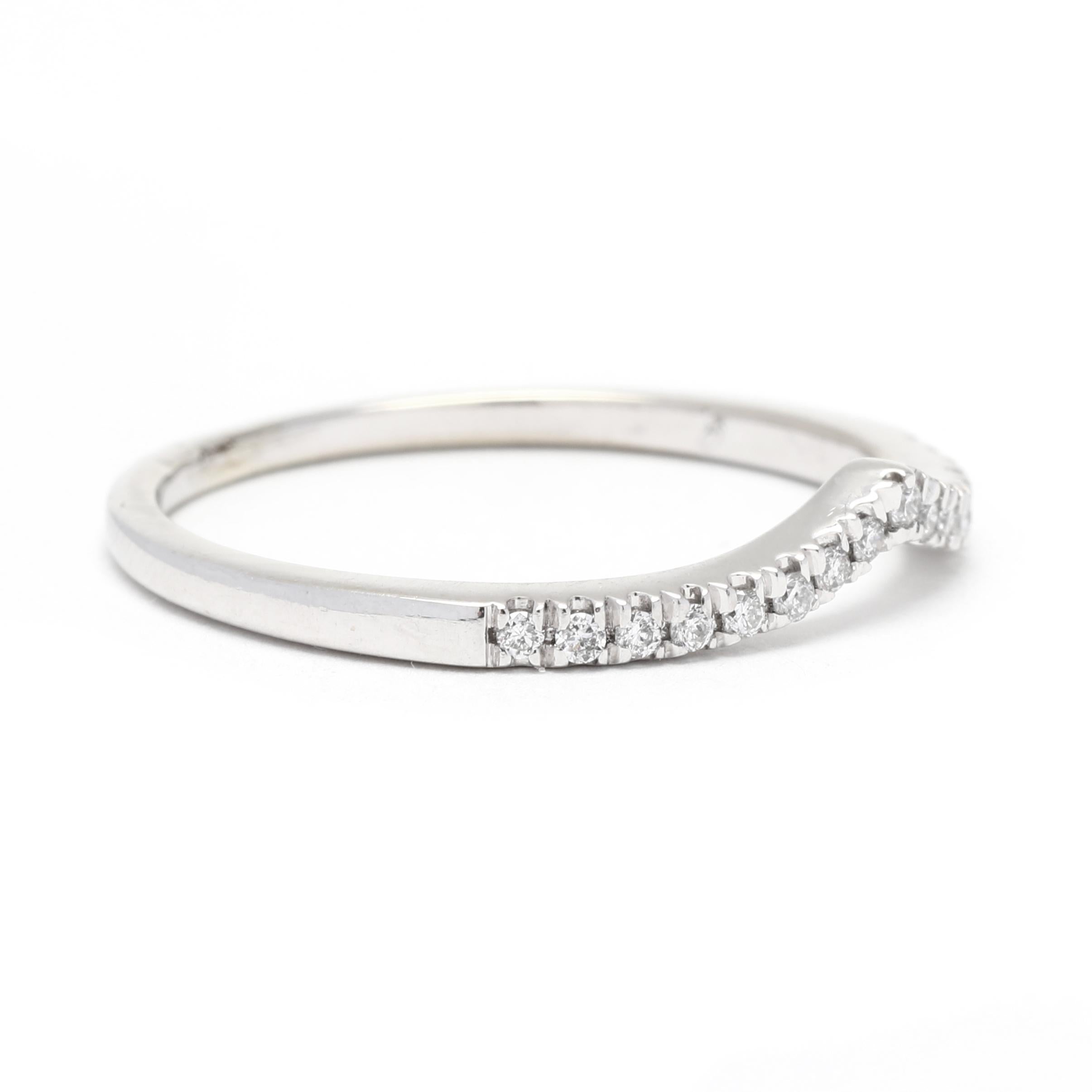 This 0.18ctw curved diamond wedding band is a stunning, timeless piece crafted from 10K white gold. A simple, yet elegant design, this V-shaped band is set with 0.18ctw of round diamonds, adding the perfect touch of sparkle and shine. This ring is