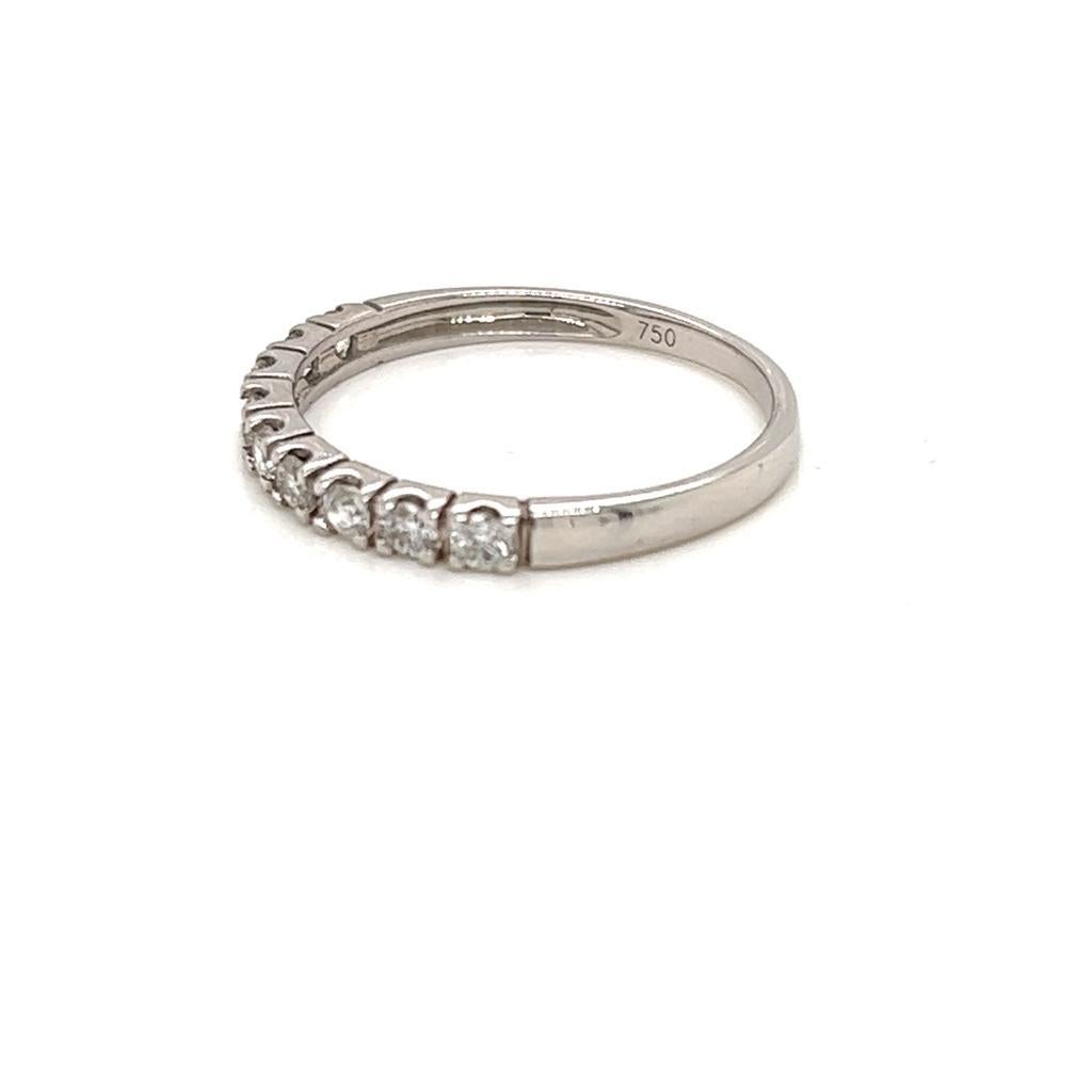 0.2 Carat Round Brilliant Diamond Half-Eternity Ring in 18 Karat White Gold

This dainty half-eternity band features a row of round brilliant Diamonds weighing a total of 0.2 carats and set in a micro setting on an 18K White Gold band.