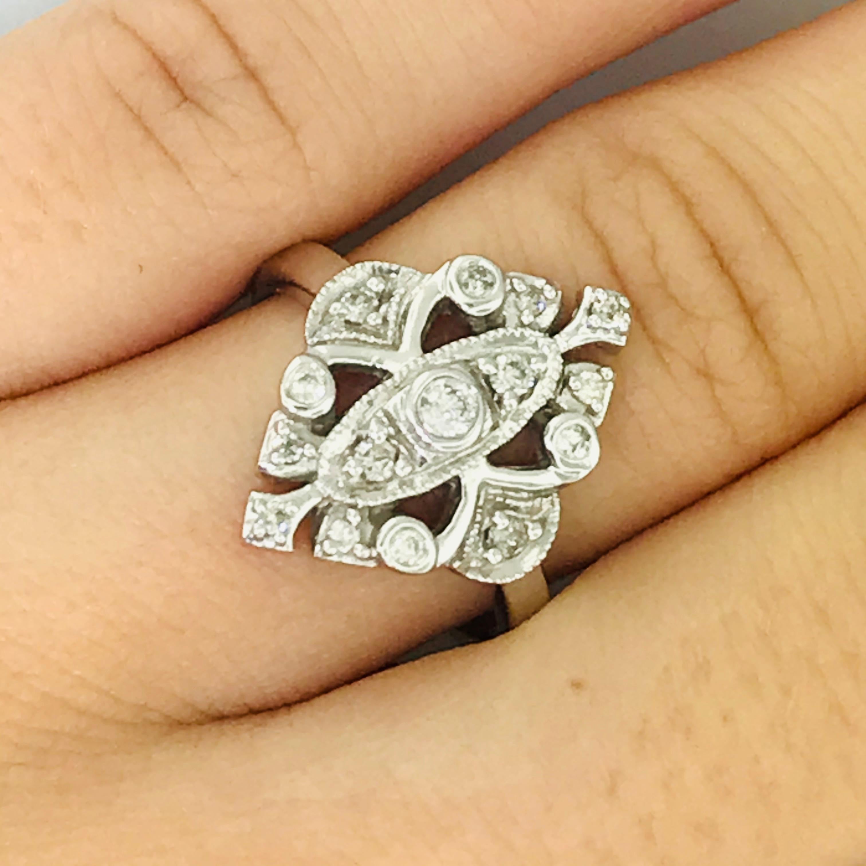 Detailing at its Finest! This gorgeous, vintage engagement ring is in amazing condition with bright white diamonds covering the top. The ring has hand crafted miligrain edges around the setting and a total of 15 round diamonds. This ring is a great