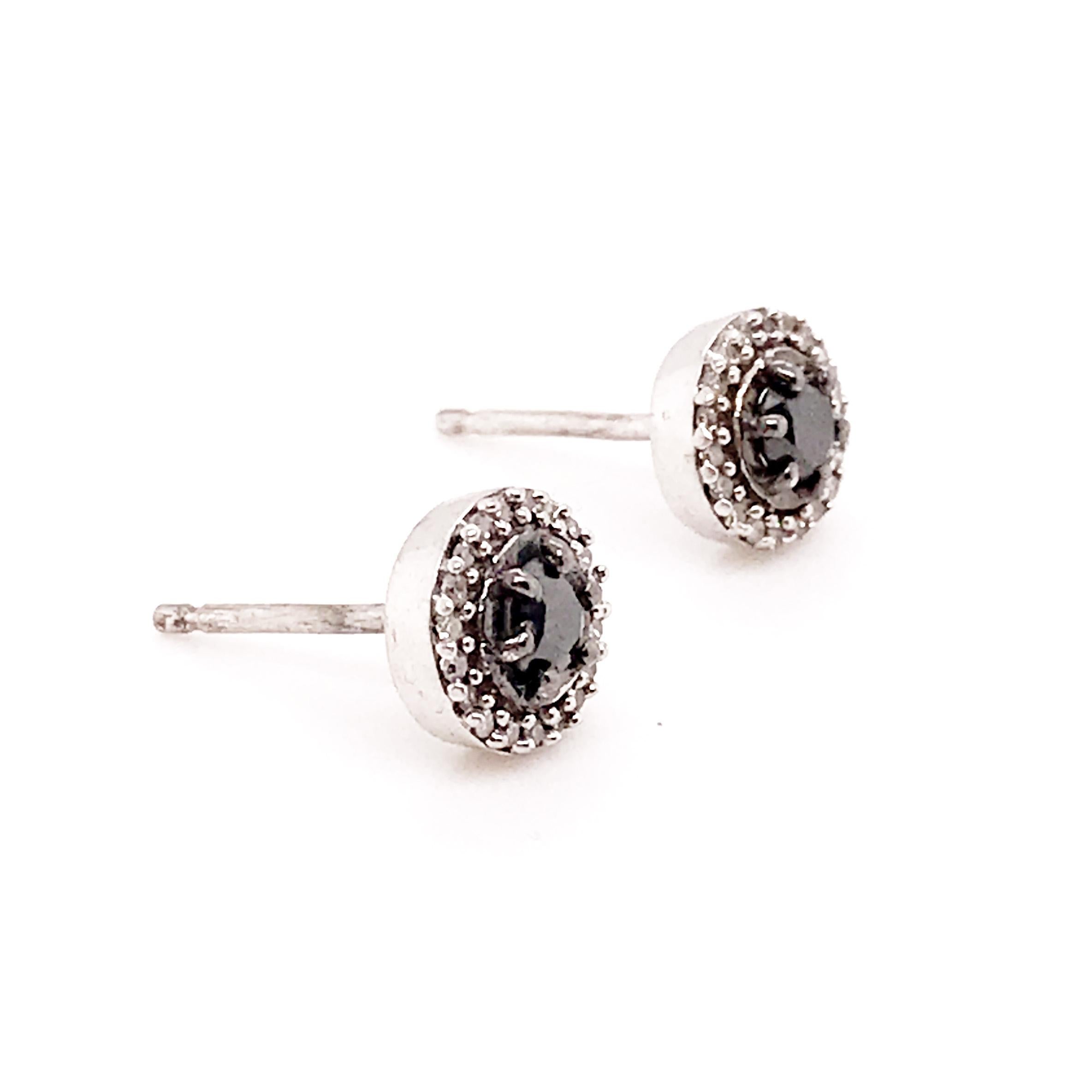 The .20 carat DIAMOND EARRING studs are a bold look with two genuine black diamonds set in the center. The black diamonds are rare and believed to be the toughest form of any natural diamond. These genuine, natural black diamonds are encased in a