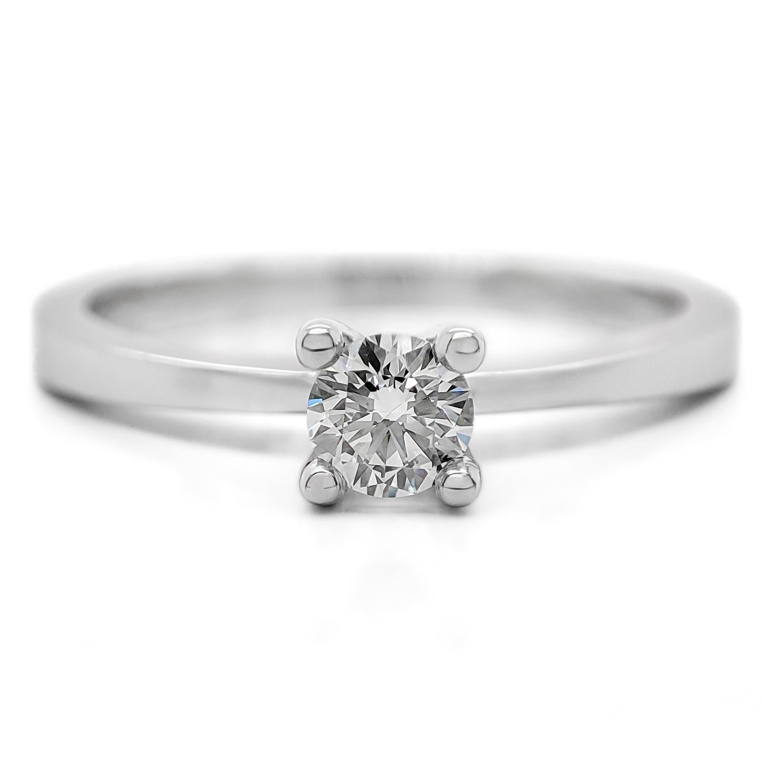 FOR US BUYER NO VAT

This solitaire engagement ring is a timeless symbol of your love and commitment. It features a brilliant 0.20 carat round diamond as its centerpiece, radiating its captivating and enduring sparkle.

The ring is crafted in 18K