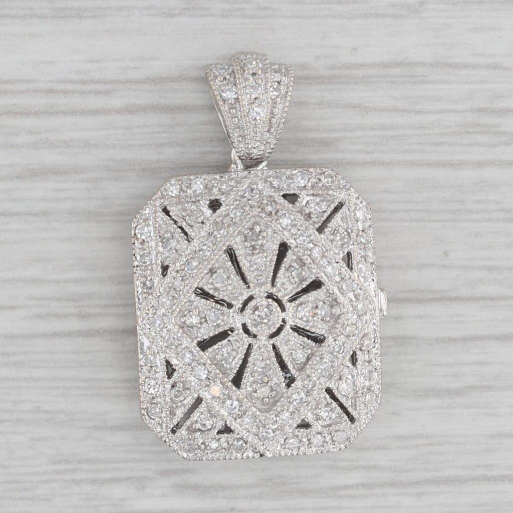 This lovely diffuser style pendant has elegant open work allowing scents to pass through. The locket design opens to reveal a hollow inside.

Gemstone Information:
- Natural Diamonds -
Total Carats - 0.20ctw
Cut - Single
Color - F - H
Clarity -