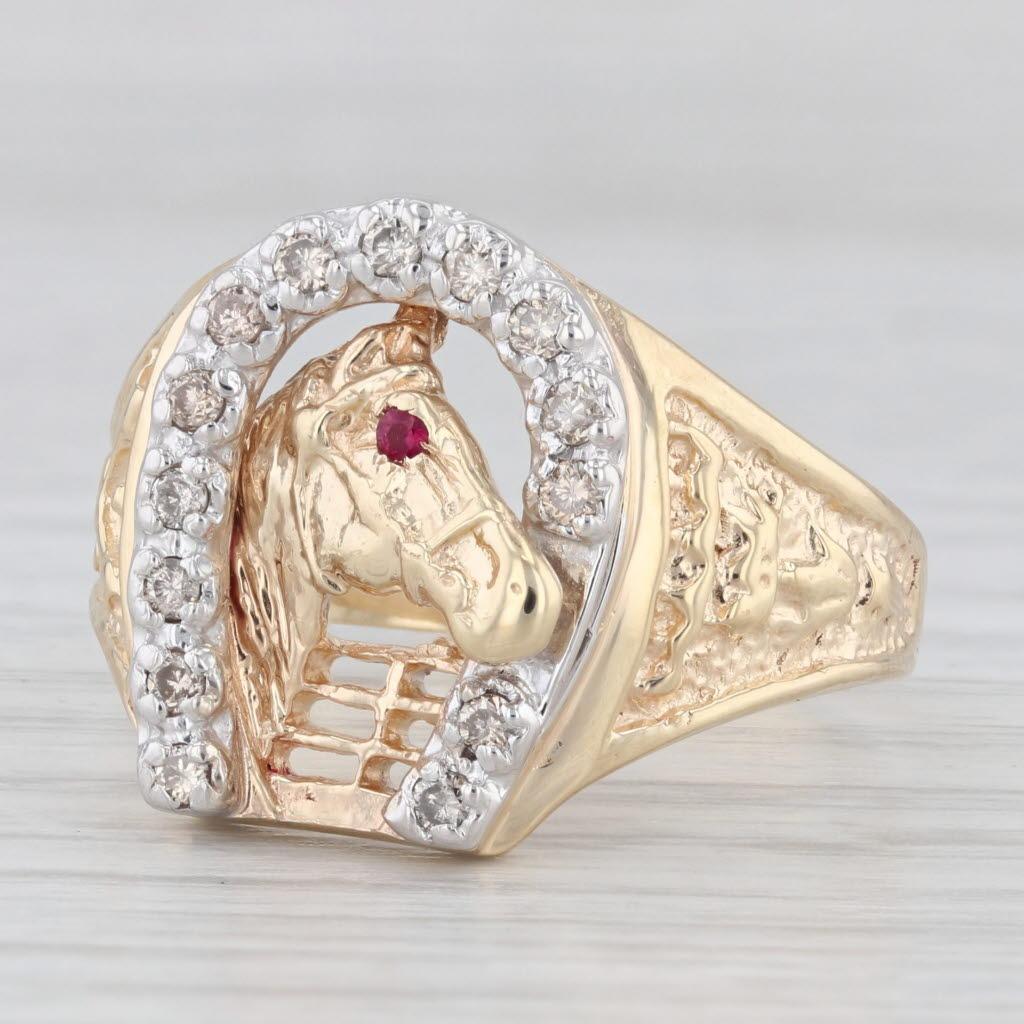 Gemstone Information:
- Natural Diamonds -
Total Carats - 0.20ctw
Cut - Round Brilliant
Color - Light Brown
Clarity - SI1 - I1

- Lab Created Ruby -
Cut - Round
Color - Red

Metal: 14k Yellow Gold, White Gold Horseshoe
Weight: 8.3 Grams 
Stamps: