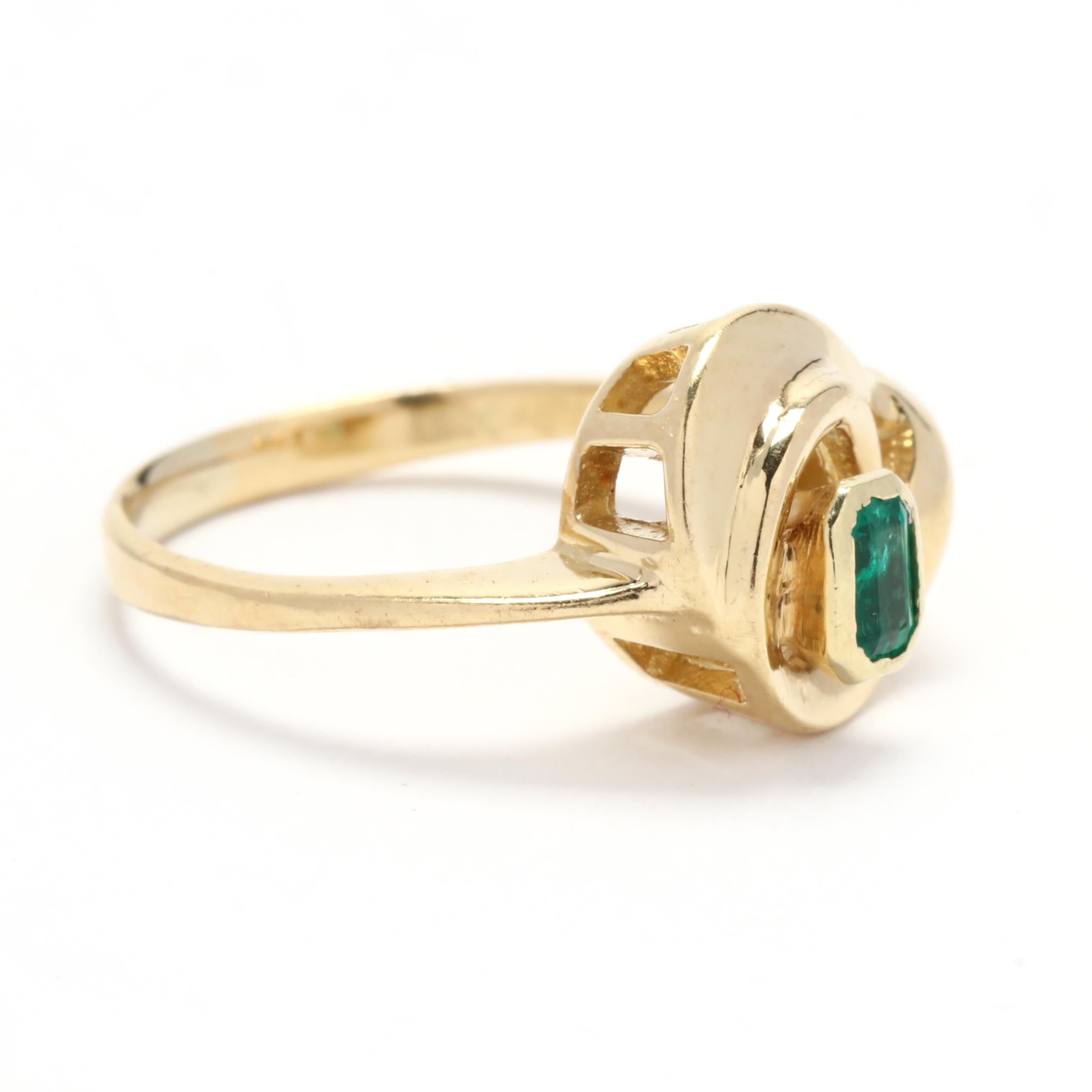 Elevate your style with this exquisite 0.20ctw Emerald Modern Ring. Crafted in 18K yellow gold, this ring boasts a beautiful emerald gemstone and a modern, swirling design. The emerald is a vivid green color, known for its rich and vibrant hue. With